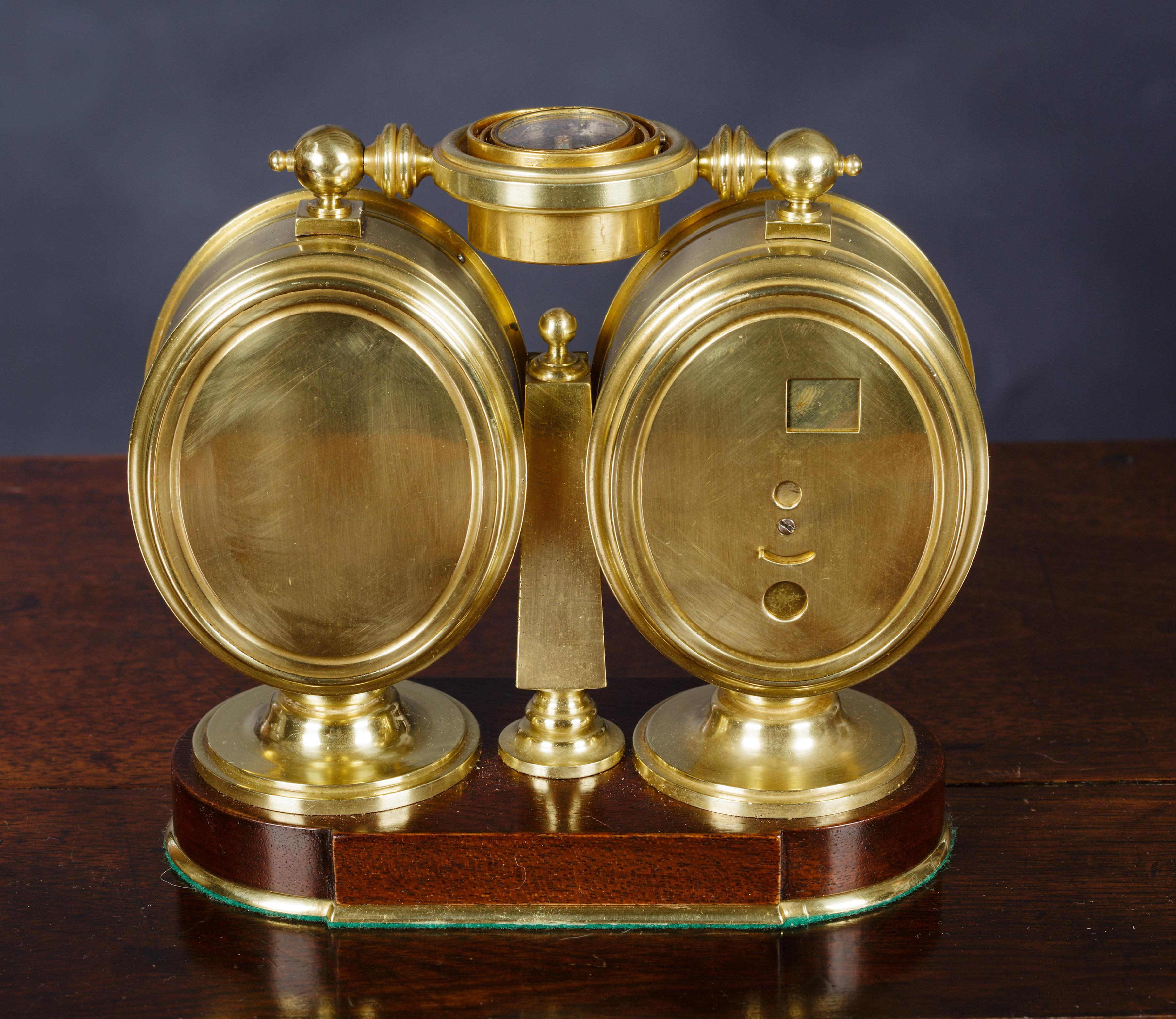Victorian clock and barometer compendium

Clock and barometer compendium standing on a shaped brass bound mahogany base with an oval shaped clock to the left and an oval shaped barometer to the right, both with fine enamel dials.

A silvered