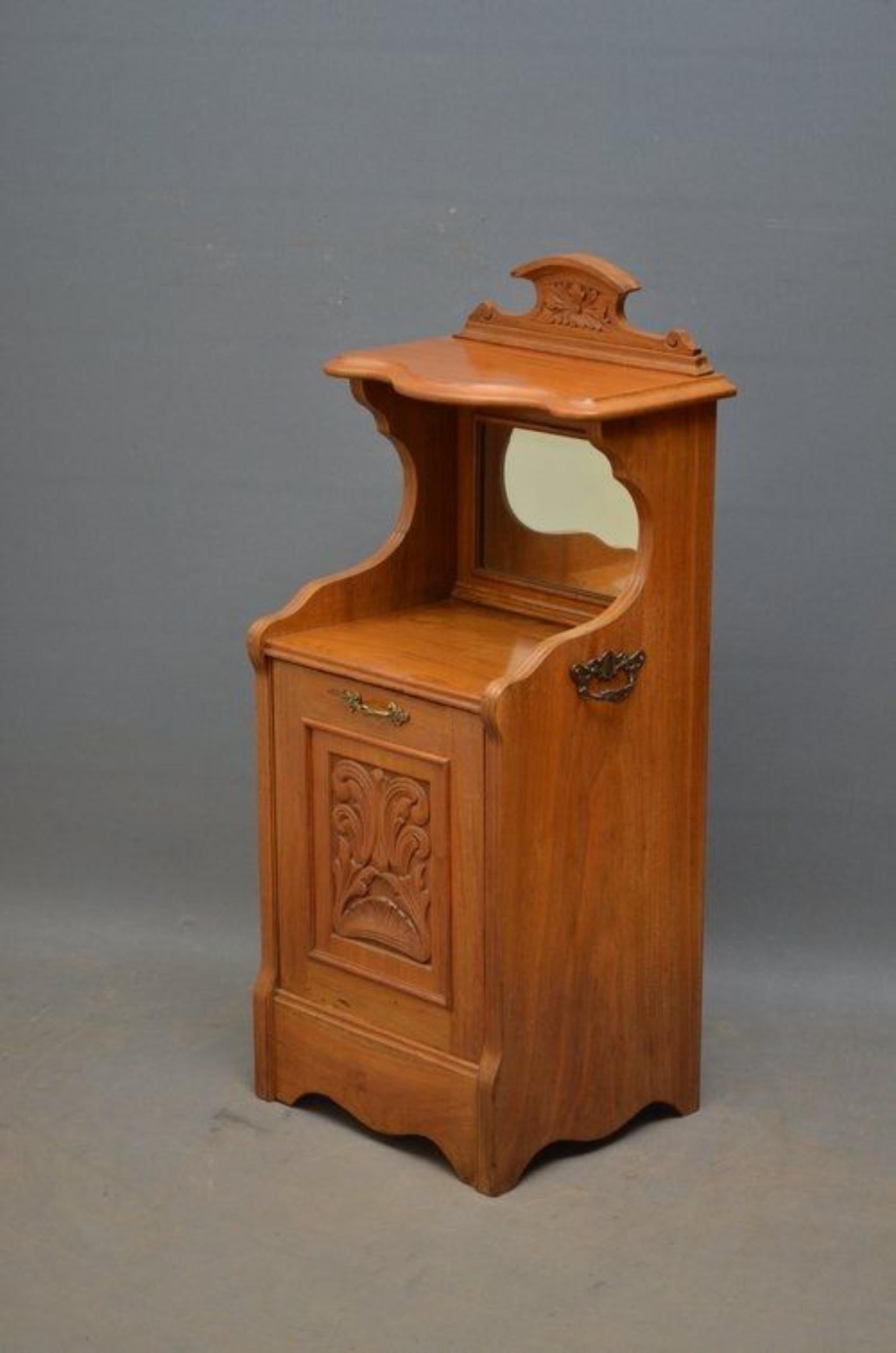 Sn722, Victorian coal scuttle in walnut, having carved upstand to back with bevelled mirror below, panelled door with carving to centre and original brass handle with carrying handles to sides, standing on shaped plinth. Would make a good bedside