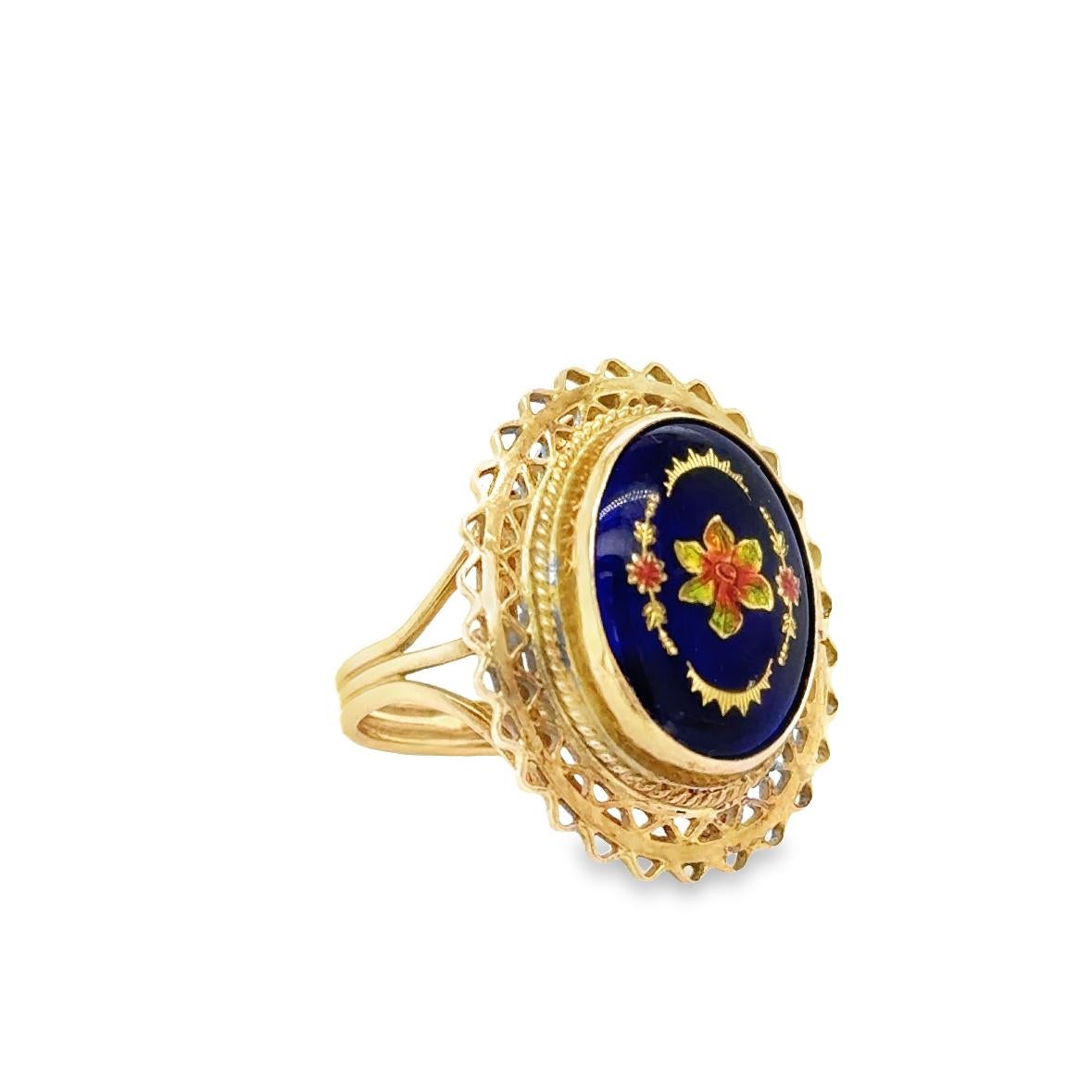 Beautiful Victorian creation crafted in 14k yellow gold. The ring shows detail throughout as the center blue gemstone is surrounded by beautifully detailed metalwork designs. 
The center oval shaped glass gemstone was a popular design for the time