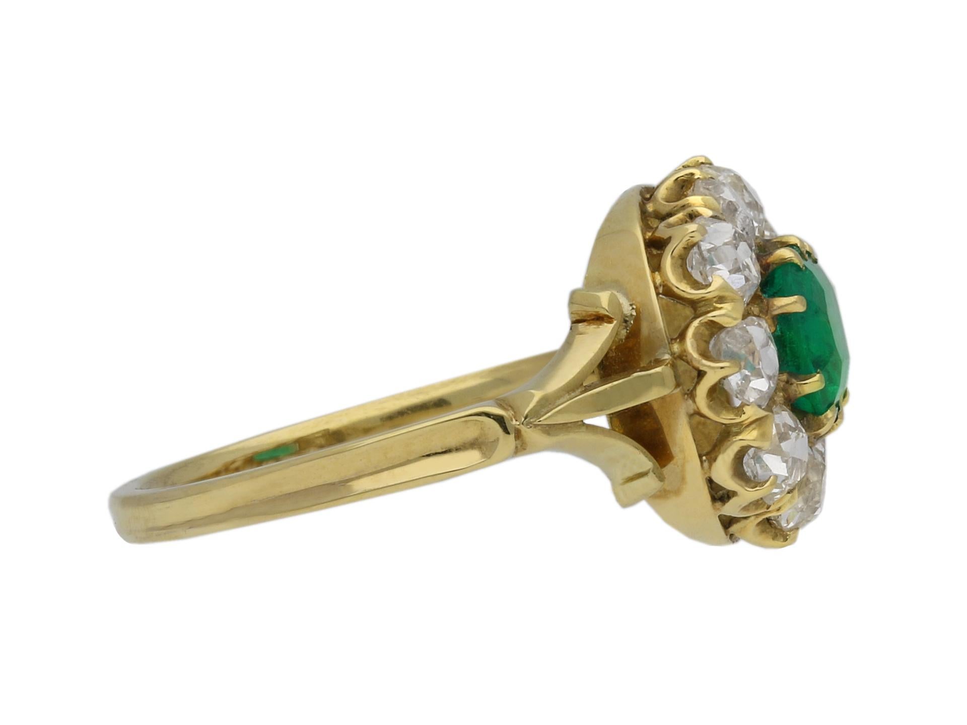 Victorian Colombian emerald and diamond coronet cluster engagement ring. Set horizontally to center with an octagonal emerald-cut natural Colombian emerald with no colour enhancement in an open back claw setting with an approximate weight of 1.20