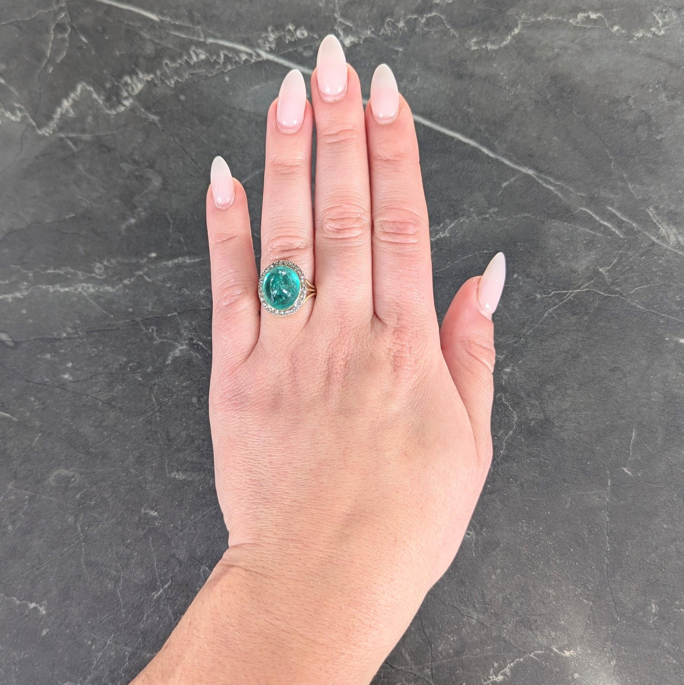 Al centro uno smeraldo colombiano cabochon di forma ovale del peso totale di circa 8,90 carati.
Trasparente di colore verde medio e incastonato in una lunetta d'oro con contorno d'argento
Perline con diamanti taglio rosa per un peso complessivo di