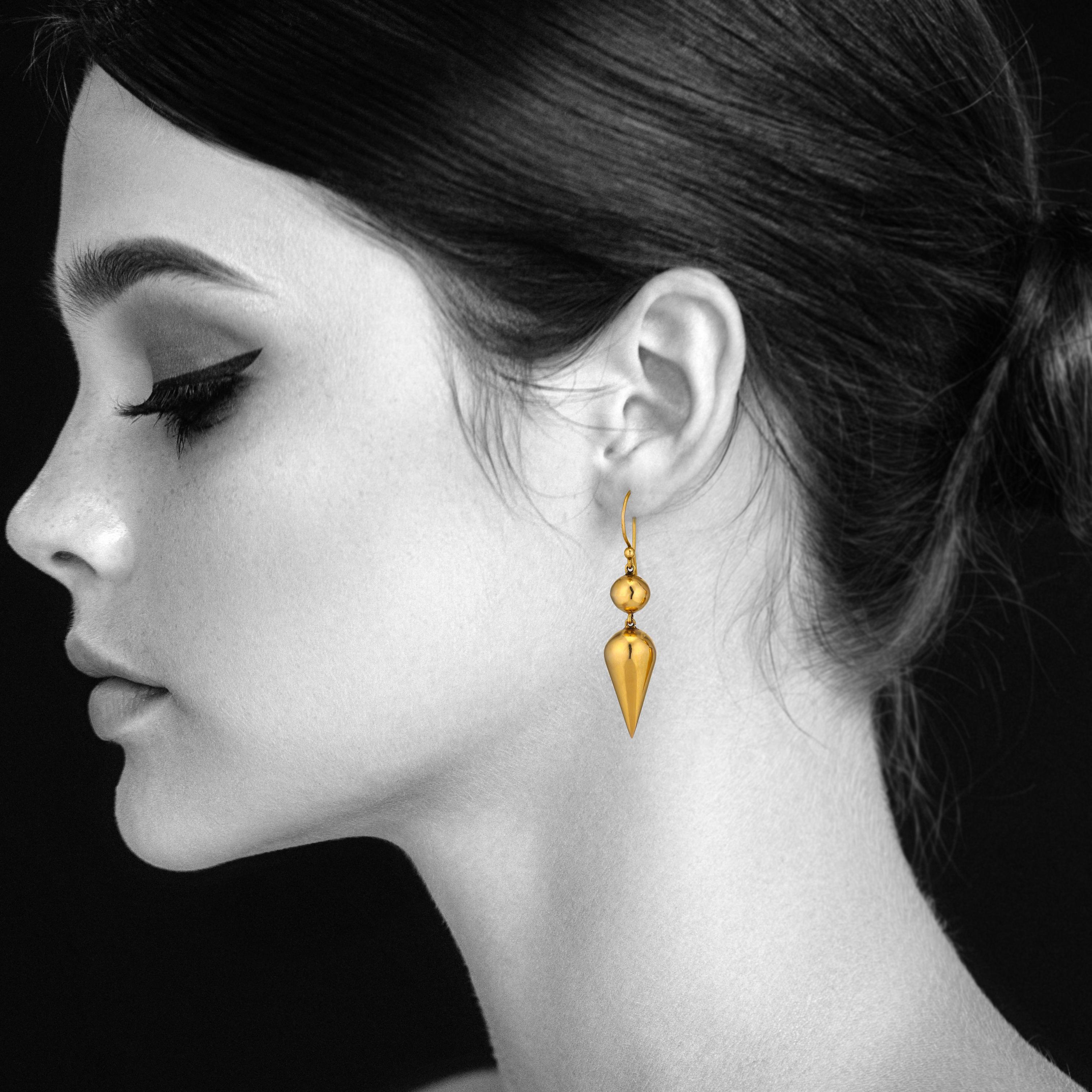 Reflecting today's modern fashion aesthetic, these Victorian handmade cone and ball earrings are stylishly current.  With a warm honeyed patina and a clean architectural silhouette, these 14 karat yellow gold earrings move and dance like they were