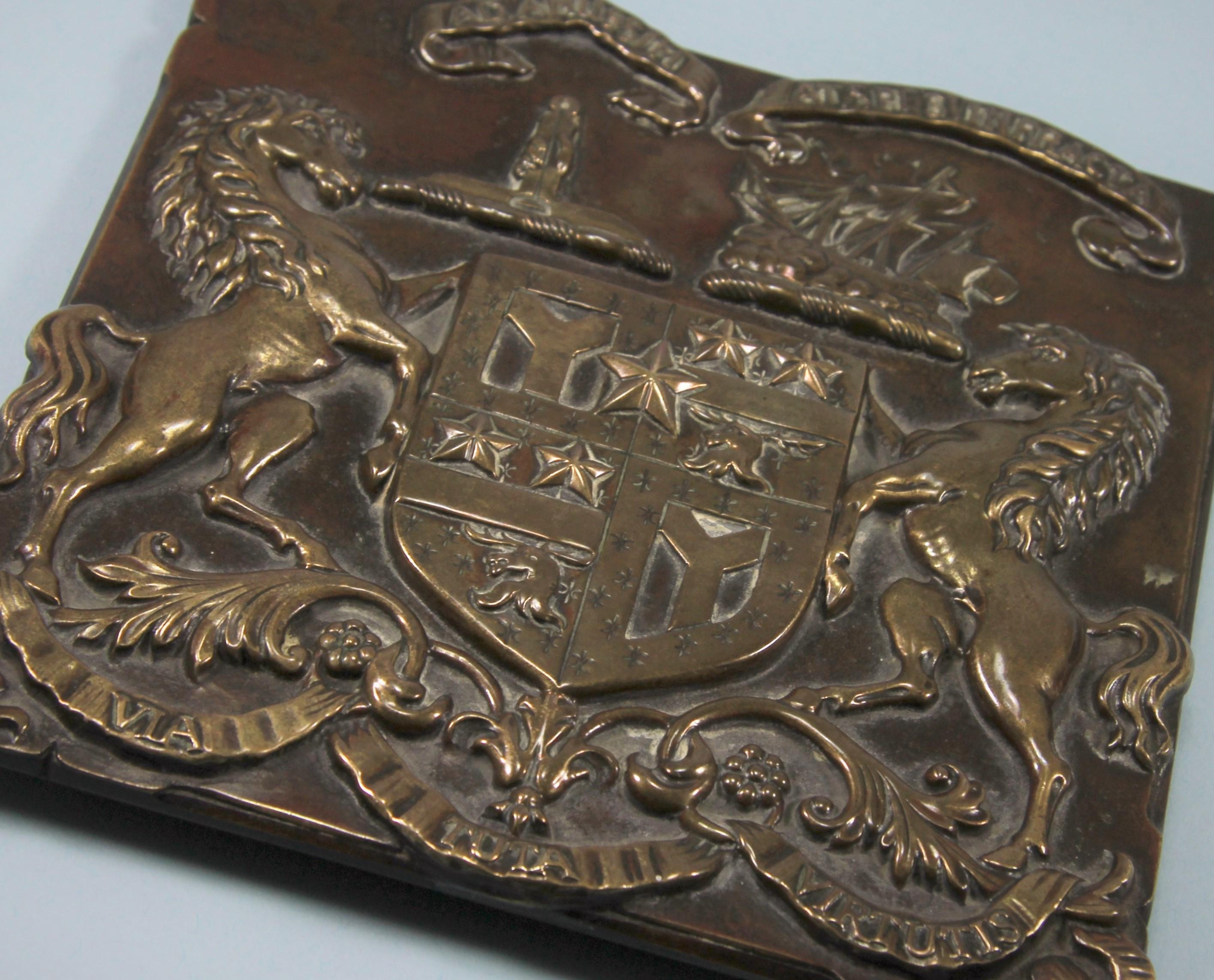 A fine example of a late-19th century copper coach plate attributed to a member of the Smith Cuninghame Family of Caprington Castle, Kilmarnock, Ayrshire, circa 1890. 

Displays a full heraldic achievement with two crests and mottos above a full