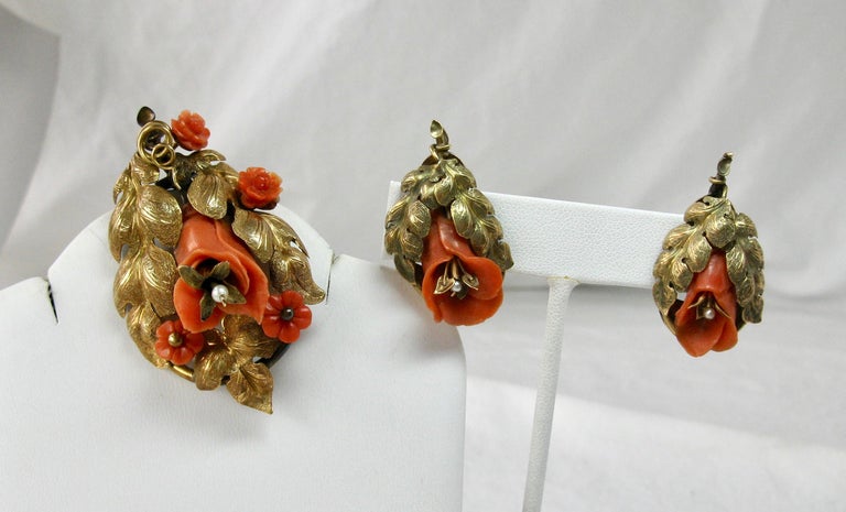 A rare pair of museum quality Etruscan Revival Victorian Coral Earrings and Brooch.  The parure with hand carved three dimensional flowers of natural coral.  The carving of the flowers is absolutely exquisite!  The larger flowers have pearl centers.