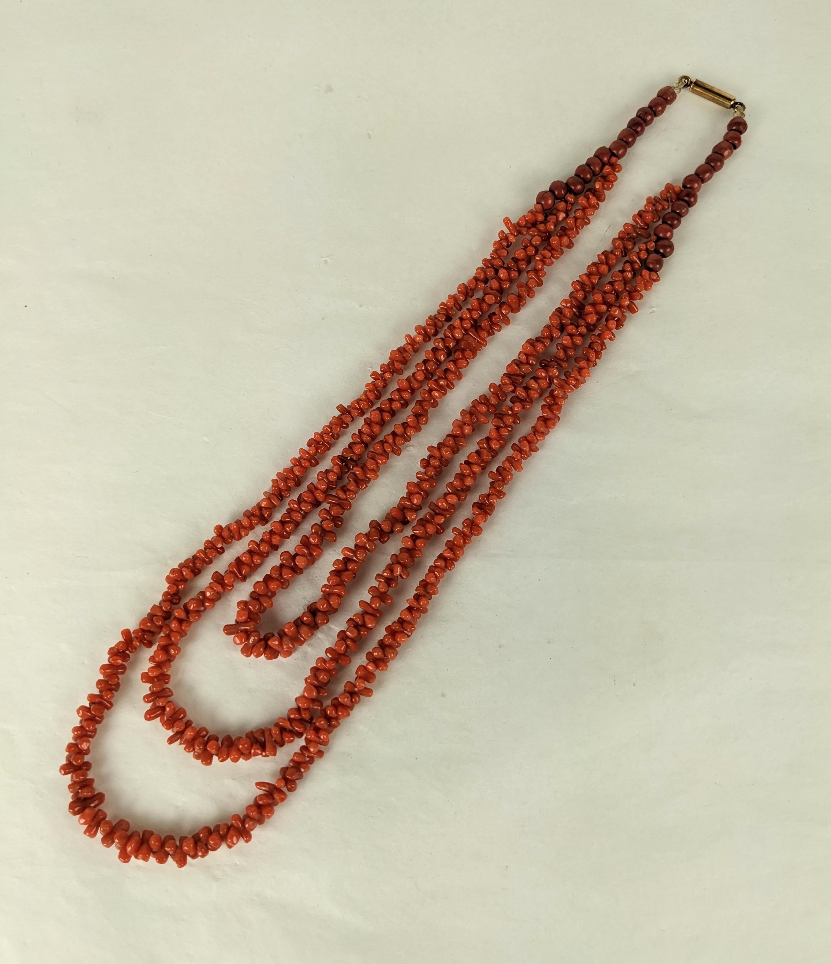 Victorian Coral 3 Strand Toggle Necklace from the late 19th Century. Composed of 3 strands of carved toggle beads which fall from larger coral resin beads at clasp which may have been added in the period to elongate the toggle beads. 1870's Italy.