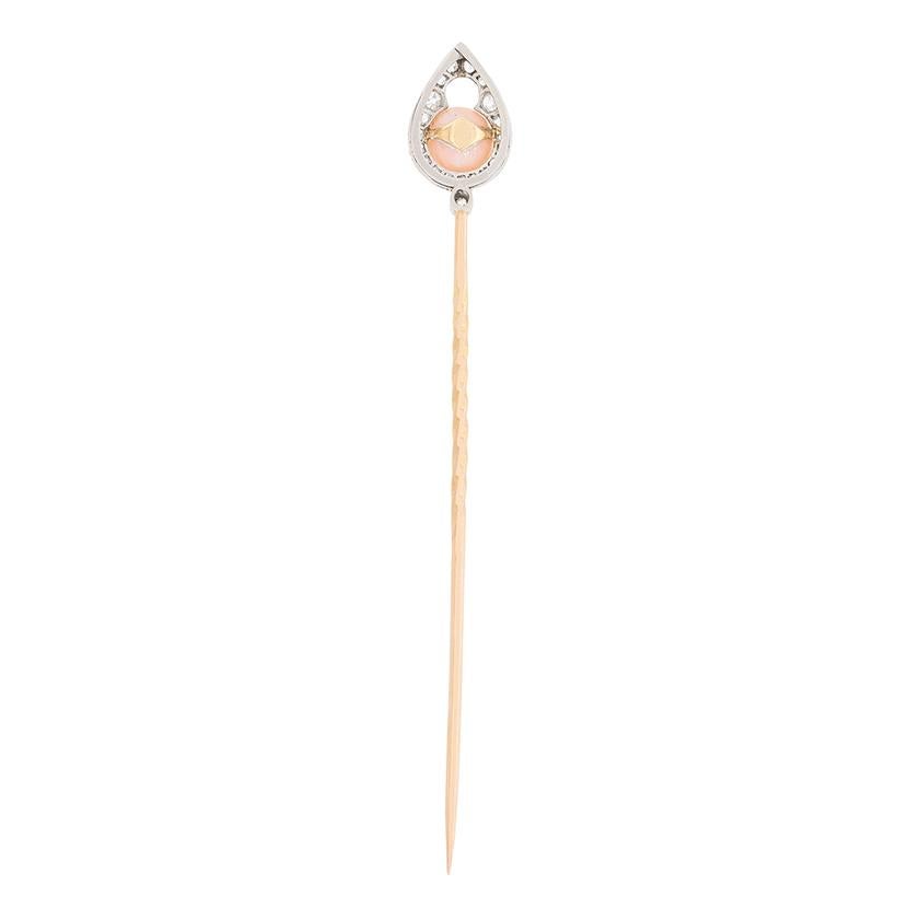 This beautiful little brooch features a peach coloured coral stone on the top. It measures 6.3mm and sits within a halo of old cut diamonds. The diamonds total 0.50 carat in weight and are H in colour and SI clarity. They are grain set within a hand