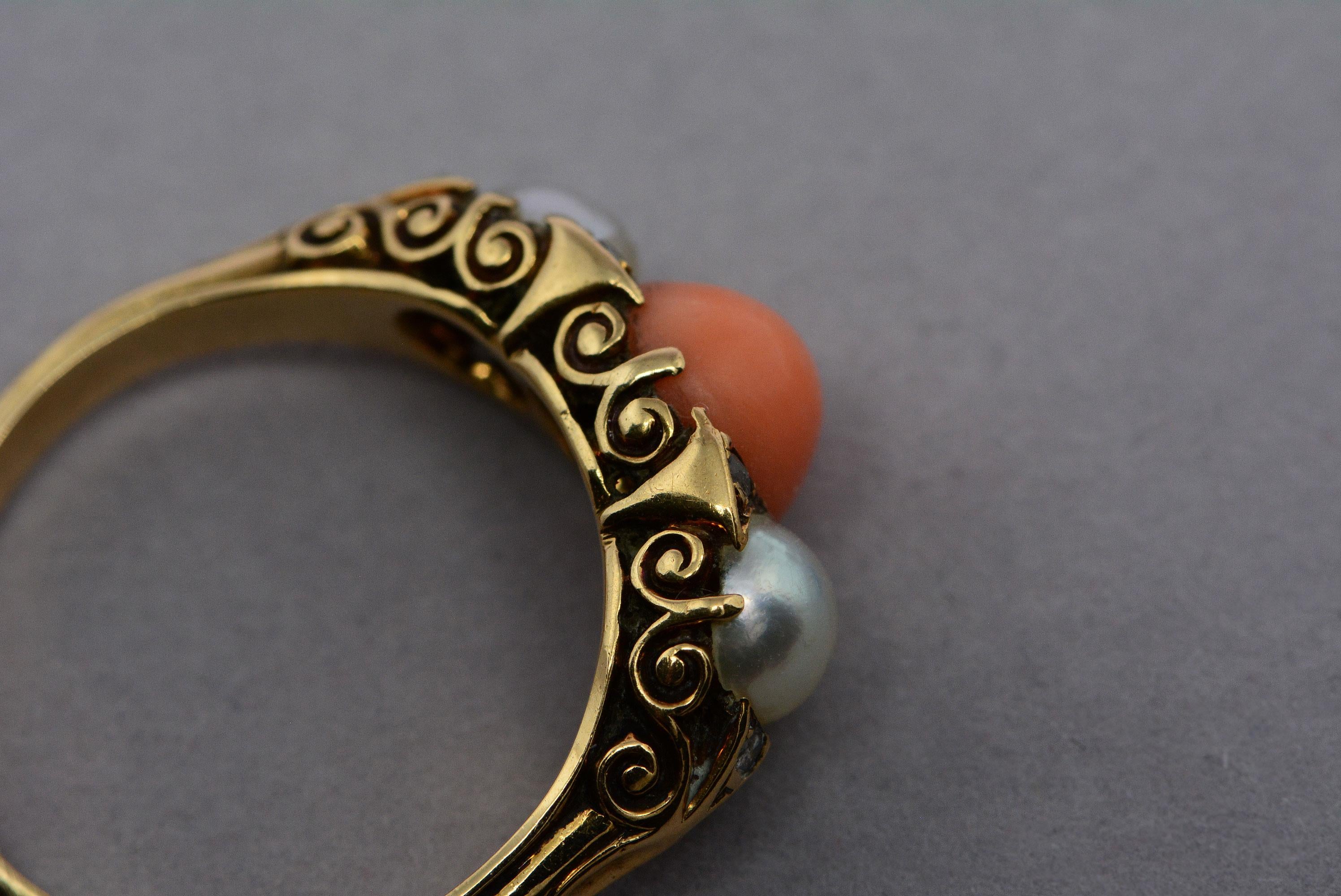 This half hoop ring was handcarved during the victorian era and has a gorgeous angelskin coral cabochon set as the centre stone that is accented by pearls and diamonds. 
Coral has been used in jewellery since ancient times, often attributed with