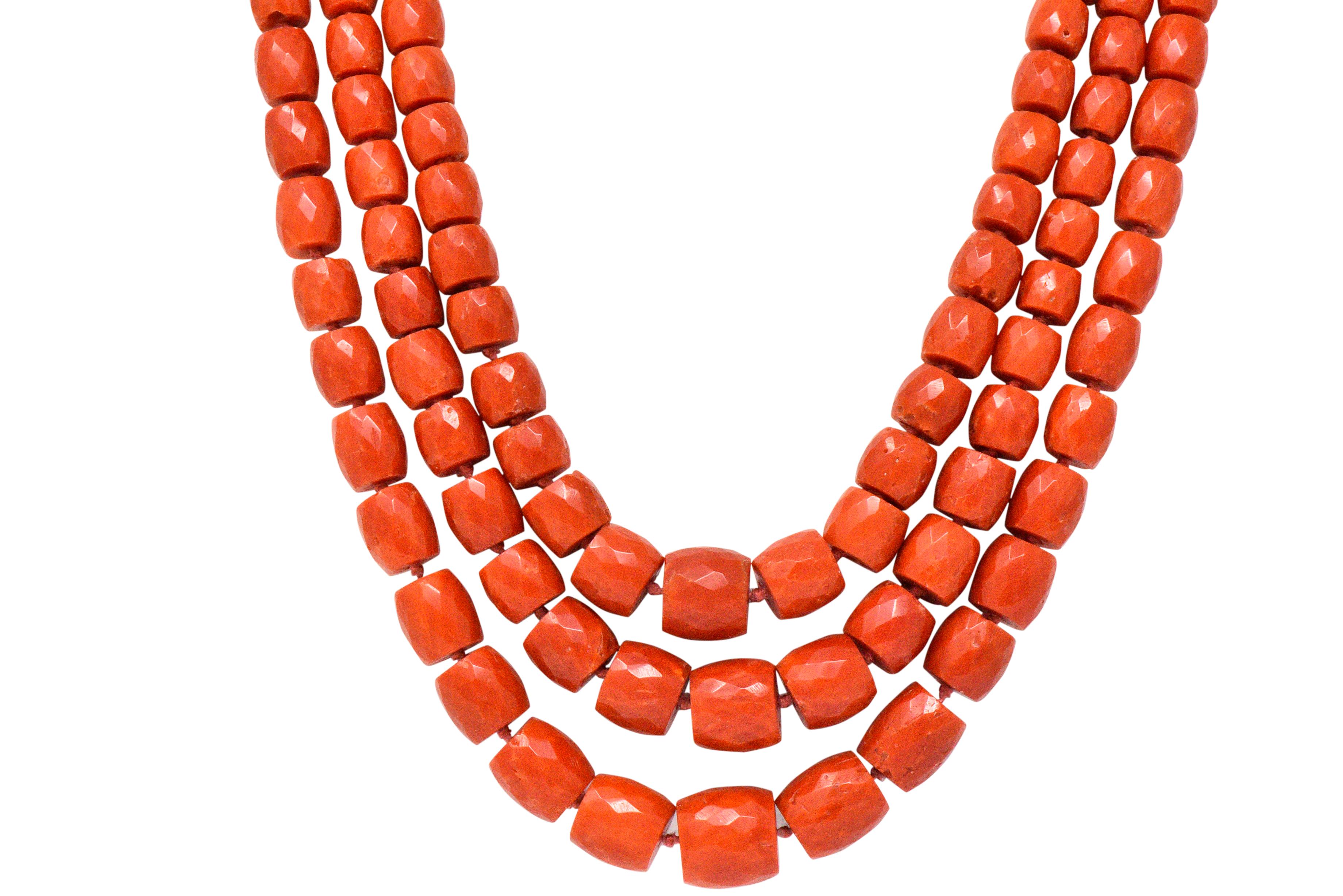 Featuring 3 strands of graduated, faceted, tubular shaped natural coral beads, 174 beads, measuring approximately 6.0 x 6.7 to 11.3 x 12.2 mm, reddish orange

Completed by a 12 karat inscribed gold clasp with a faceted oval coral, measuring