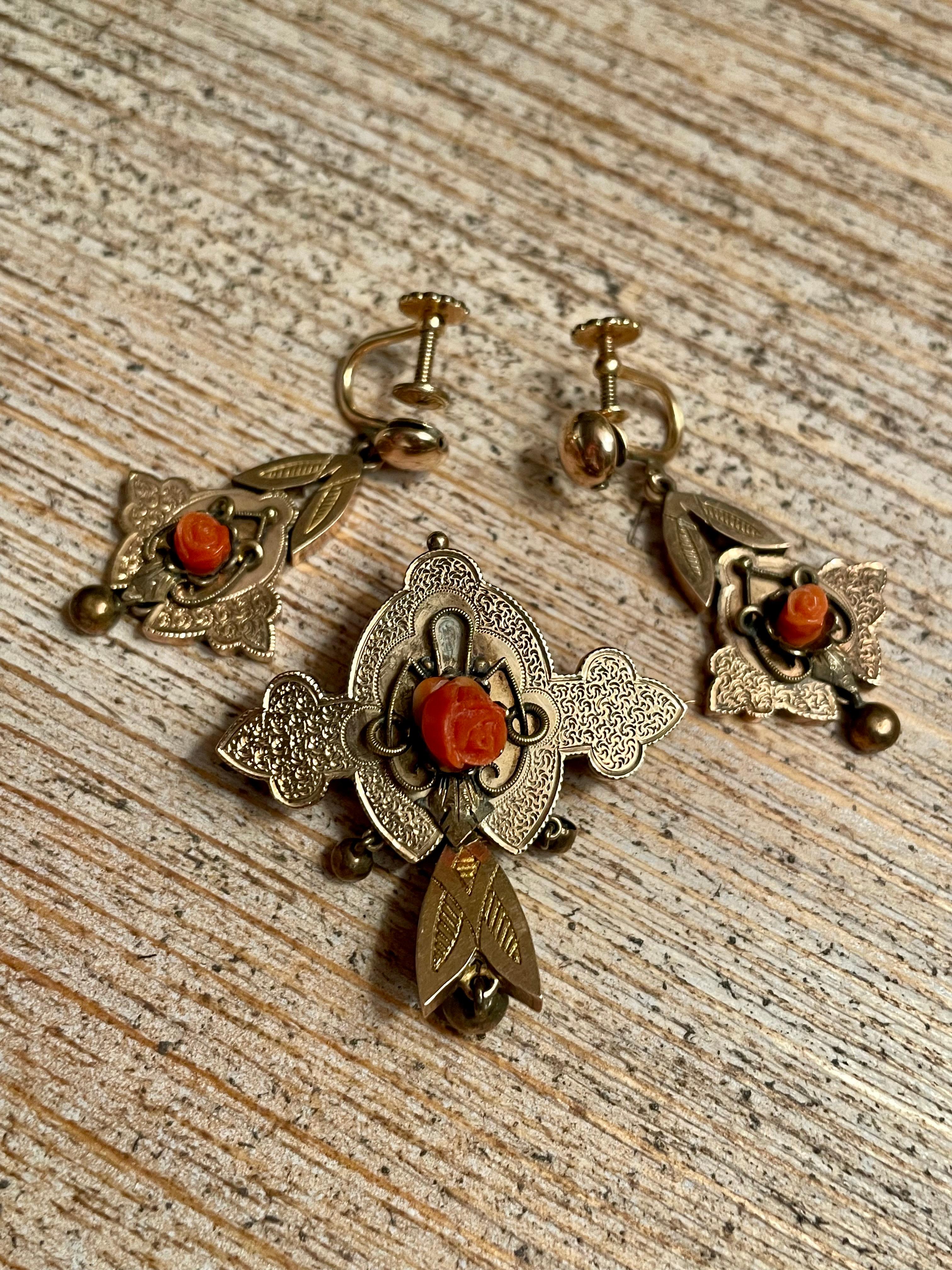 This lovely Gold-filled Victorian set consists of  matching screw back earrings and a brooch which can also be worn as a pendant.  Each piece features a floral design of Coral carved.  

Stamp:  1/20 12k GF

Brooch/Pendant dimensions: approximately