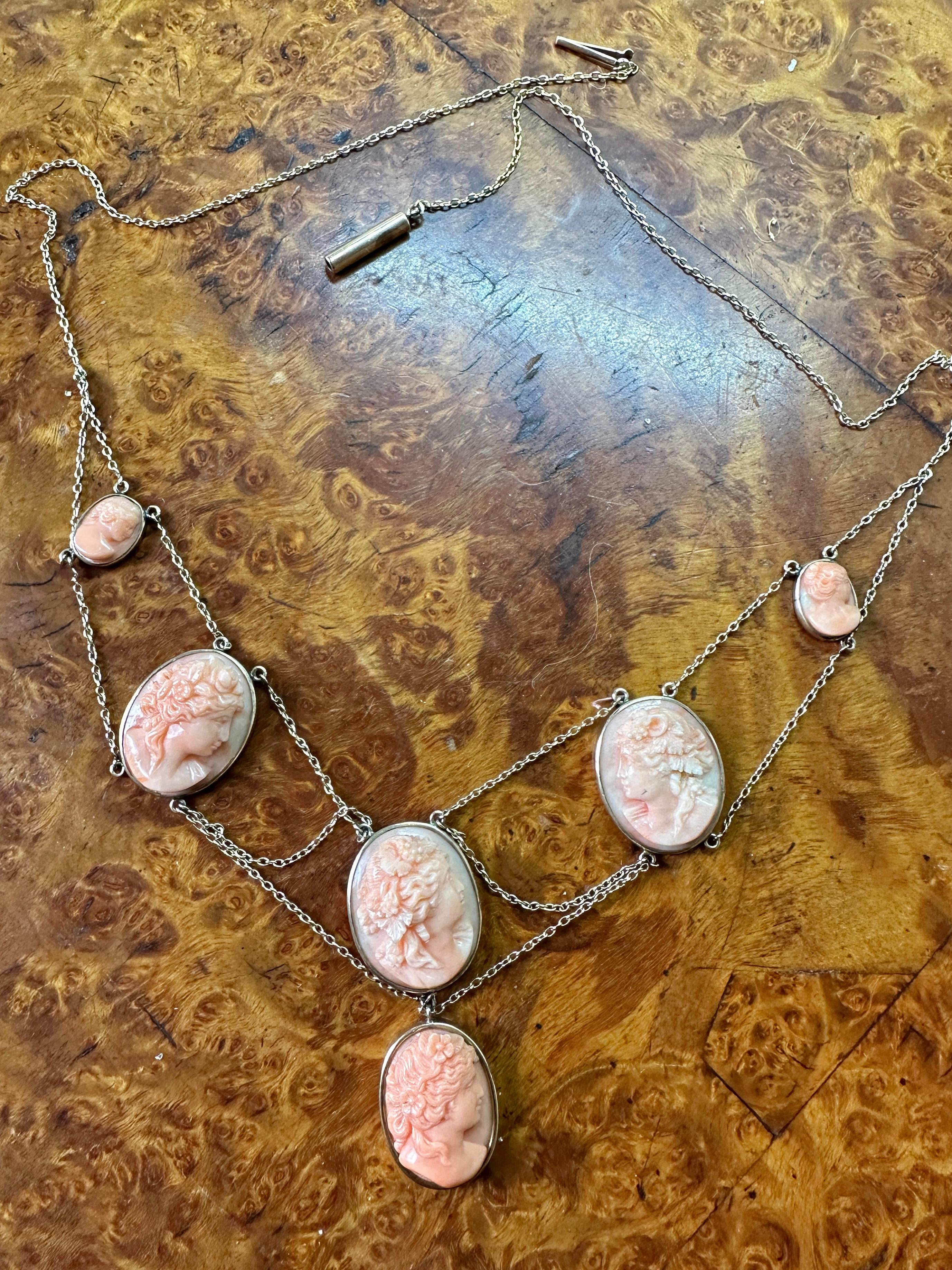 This is an absolutely stunning early antique Coral Cameo Festoon Pendant Necklace in 14 Karat Gold dating to the Victorian period with six magnificent hand carved maiden woman goddess Coral Cameos of great beauty.
The Coral Cameos are all different