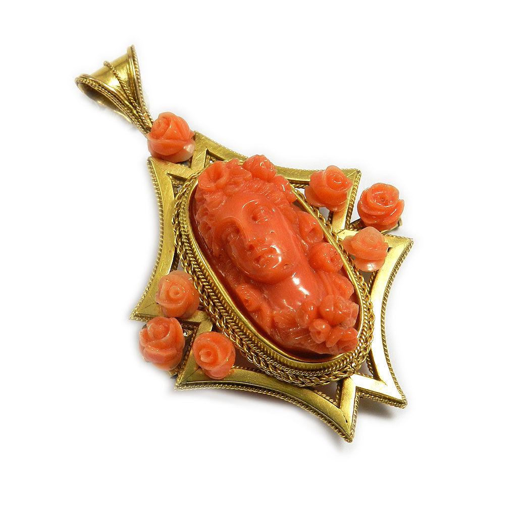 Victorian coral cameo gold Brooch Pendant Goddess Flora, circa  1870

The brooch is designed as coral cameo (salmon orange in color) depicting the roman goddess Flora boldly carved. An elaborate 14K yellow gold frame set in the centre, decorated