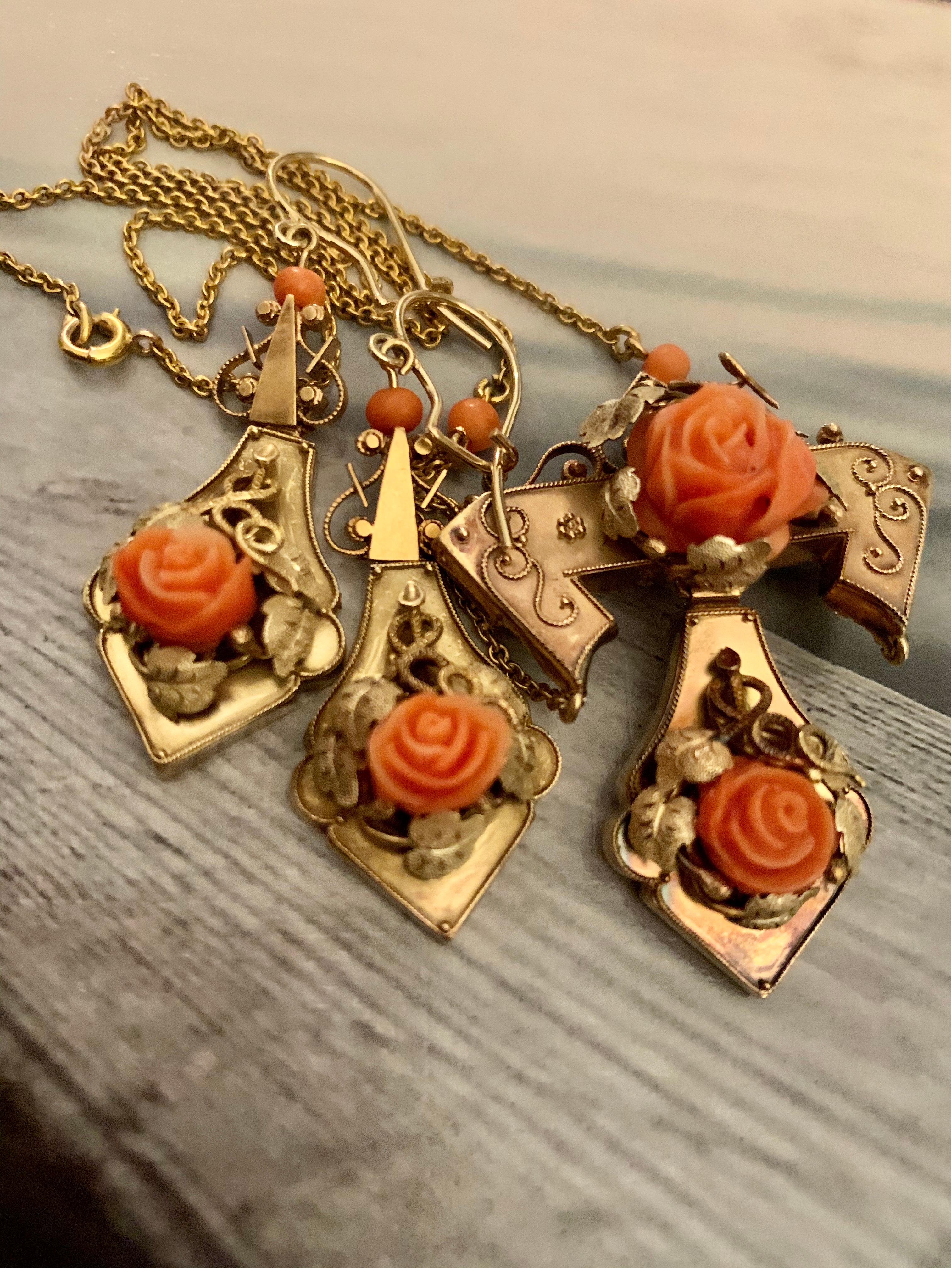 This beautiful necklace and earring set features roses which have been carved from salmon Coral. The pendant features two roses and two Coral beads on on the chain on each side of the pendant. 
 Each earring has one rose and one Coral bead.  There