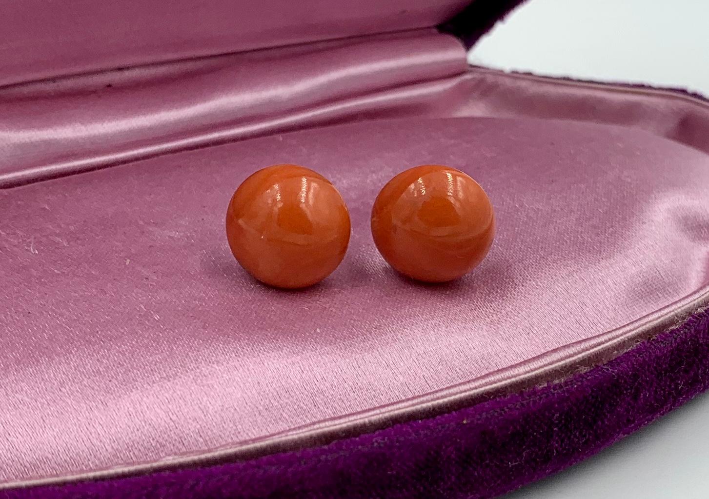 A gorgeous pair of Victorian Coral Earrings in 9 Karat Gold.  The stunning earrings have round natural Coral cabochons of 14mm (just over 1/2 inch) in diameter.  The color of the coral is a warm lovely salmon with a touch of red.   The size is