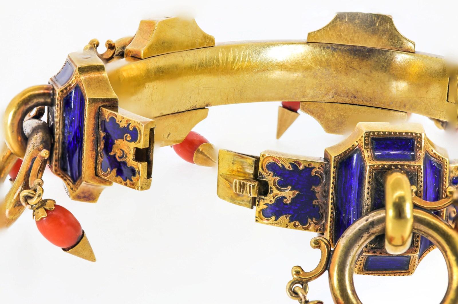 This extraordinary  one-of-a kind 1890s Victorian era bangle is crafted of 15KT yellow gold, of 6 fluted rectangular sections.  Each section features  gold  hoops dangling three orange red tear shaped Coral pendants.  Translucent cobalt blue Enamel