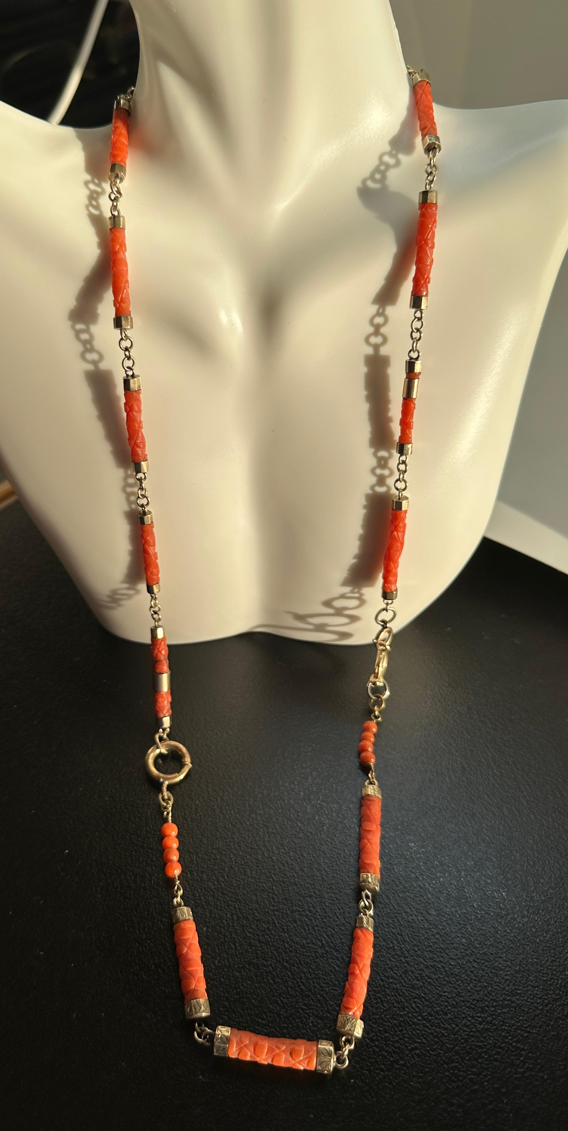 Indulge in a magnificent and very rare Antique Victorian - Art Deco Coral Necklace of hand carved Coral Beads in a Bamboo Flower Motif with engraved gold terminals and jump rings. The fabulous 24 inch long necklace dates to the Victorian period,