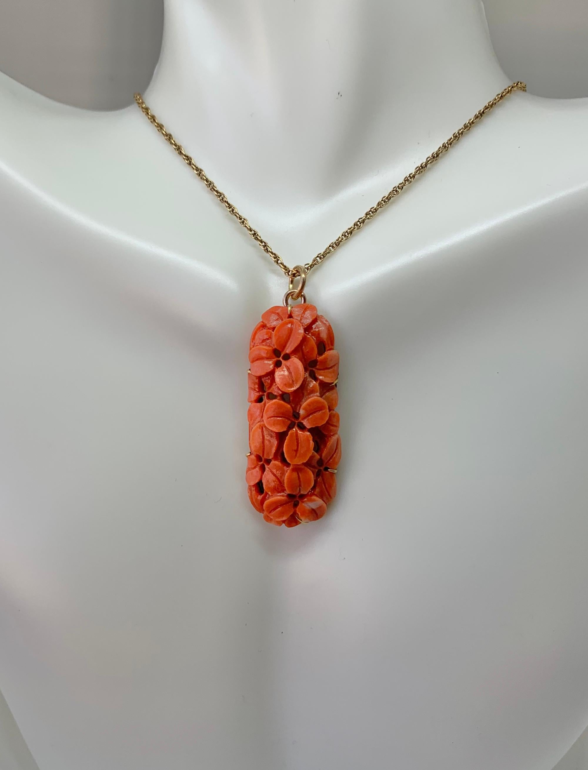 This is a stunning antique Victorian Pendant of hand carved Coral with a design of flowers or leaves.  The coral is set in 9 Karat Yellow Gold.   The coral pendant is a beautiful example of artistic expression - the leaves have incredible three