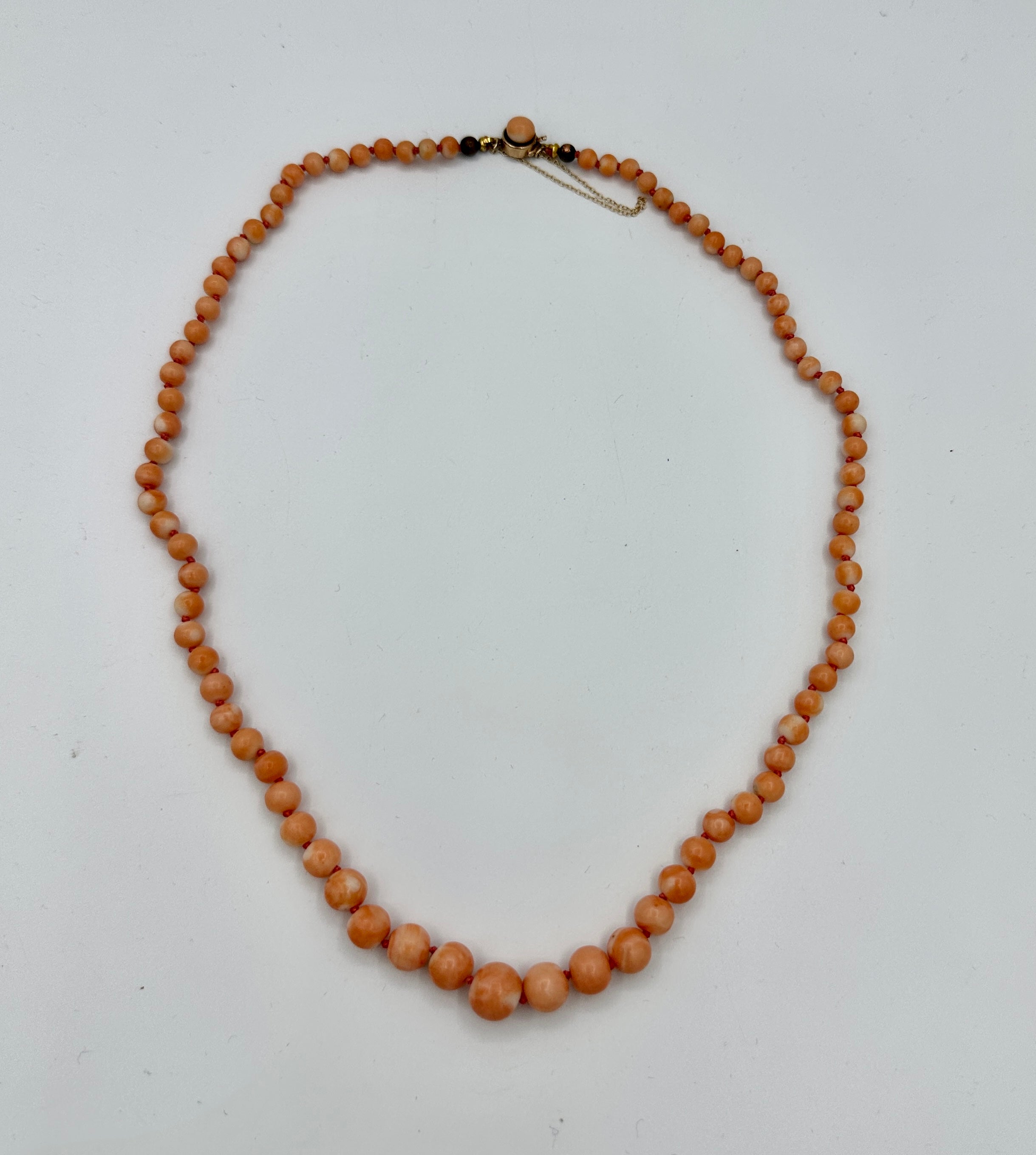 Indulge in this elegant antique Victorian - Art Deco Graduated Coral and Gold Necklace.  The magnificent Coral beads are graduated from 5mm to 10mm in diameter.  The necklace is 20 inches long.  The clasp is 10 Karat Gold with an 8mm coral bead  The
