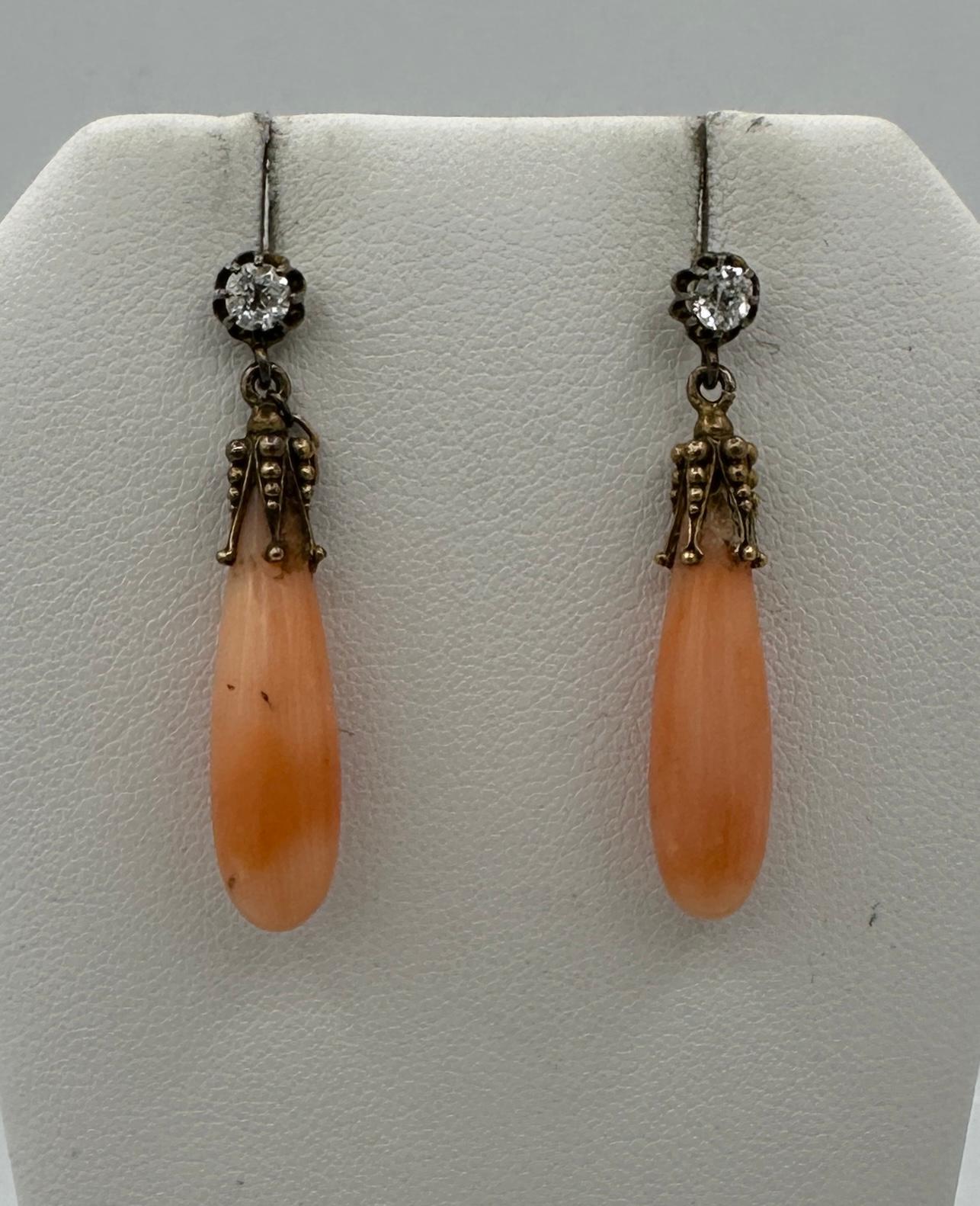 This is a gorgeous pair of antique Victorian Coral and Old Mine Cut Diamond Dangle Drop Earrings in 14 Karat Gold.  The wonderful Etruscan Revival dangle drop earrings are 1 3/8 inches long and have fabulous coral torpedo shape drops.  The coral is
