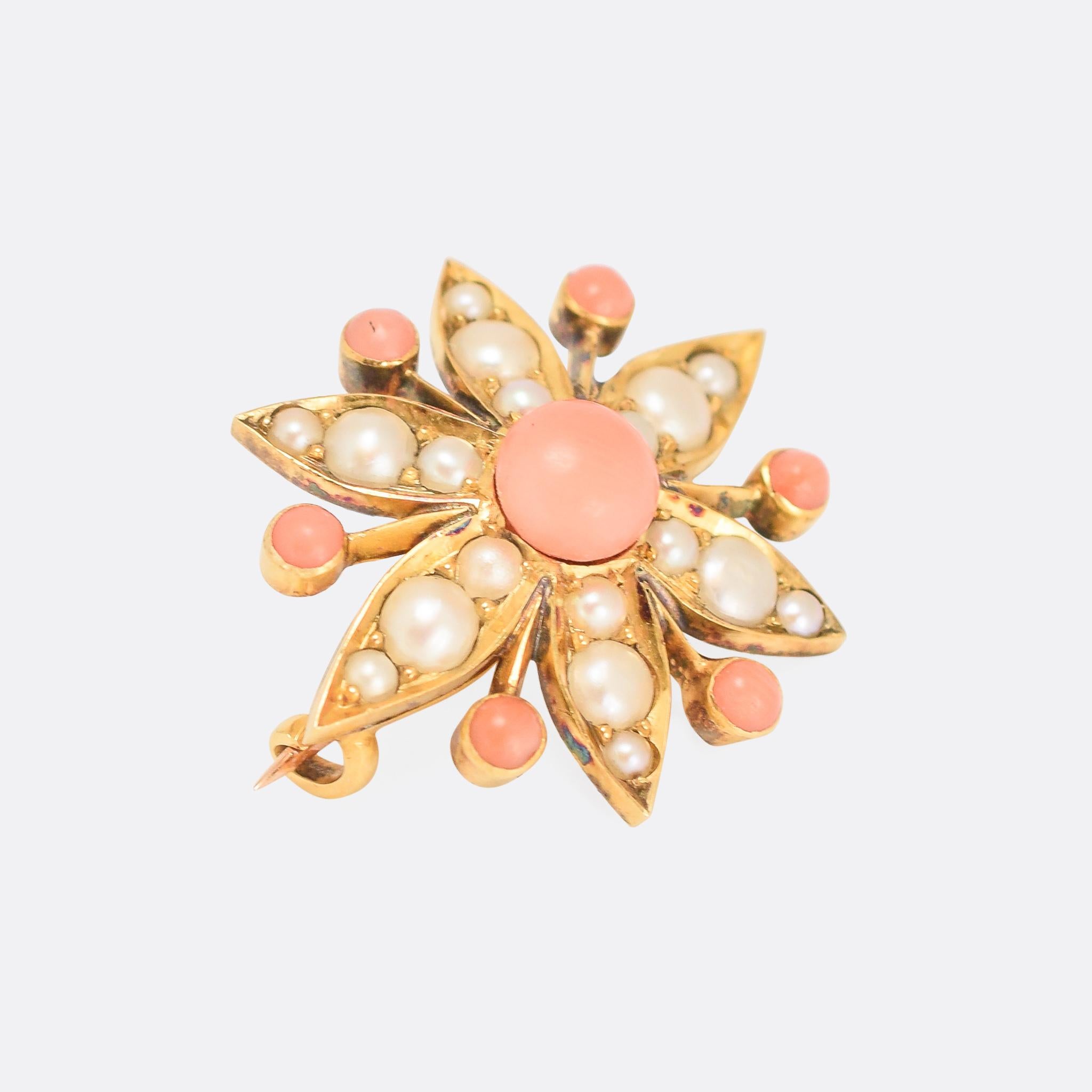 A gorgeous antique flower brooch set with coral and pearls. It's beautifully worked in 15 karat gold, with fine edges to the petals and a bezel set coral between each of them. Dating from the latter half of the 19th Century, circa 1880.

STONES