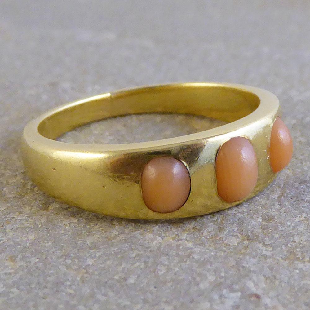 This pretty Victorian ring features three beautiful Coral stones. Set in an 18ct yellow gold band, it will make a lovely addition to your antique ring collection!

Ring Size: UK M or US 6 1/4

Condition: Very Good, slightest signs of wear due to age