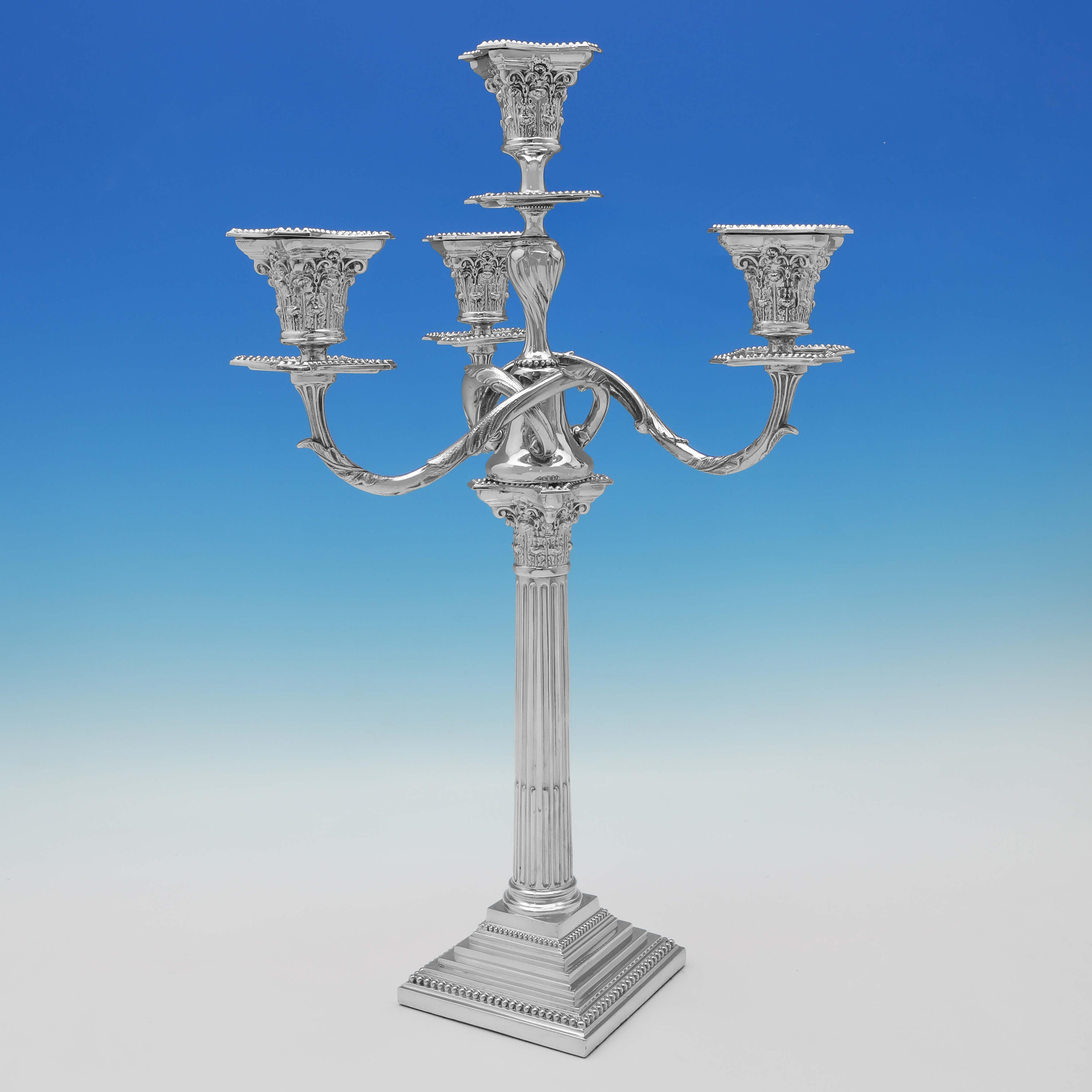 Made circa 1890 by Spurrier & Company, this stylish pair of Antique Silver Plate Candelabra, are in the Corinthian style, each holding 4 candles and featuring stepped bases and bead borders.

 Each candelabrum measures 21.5