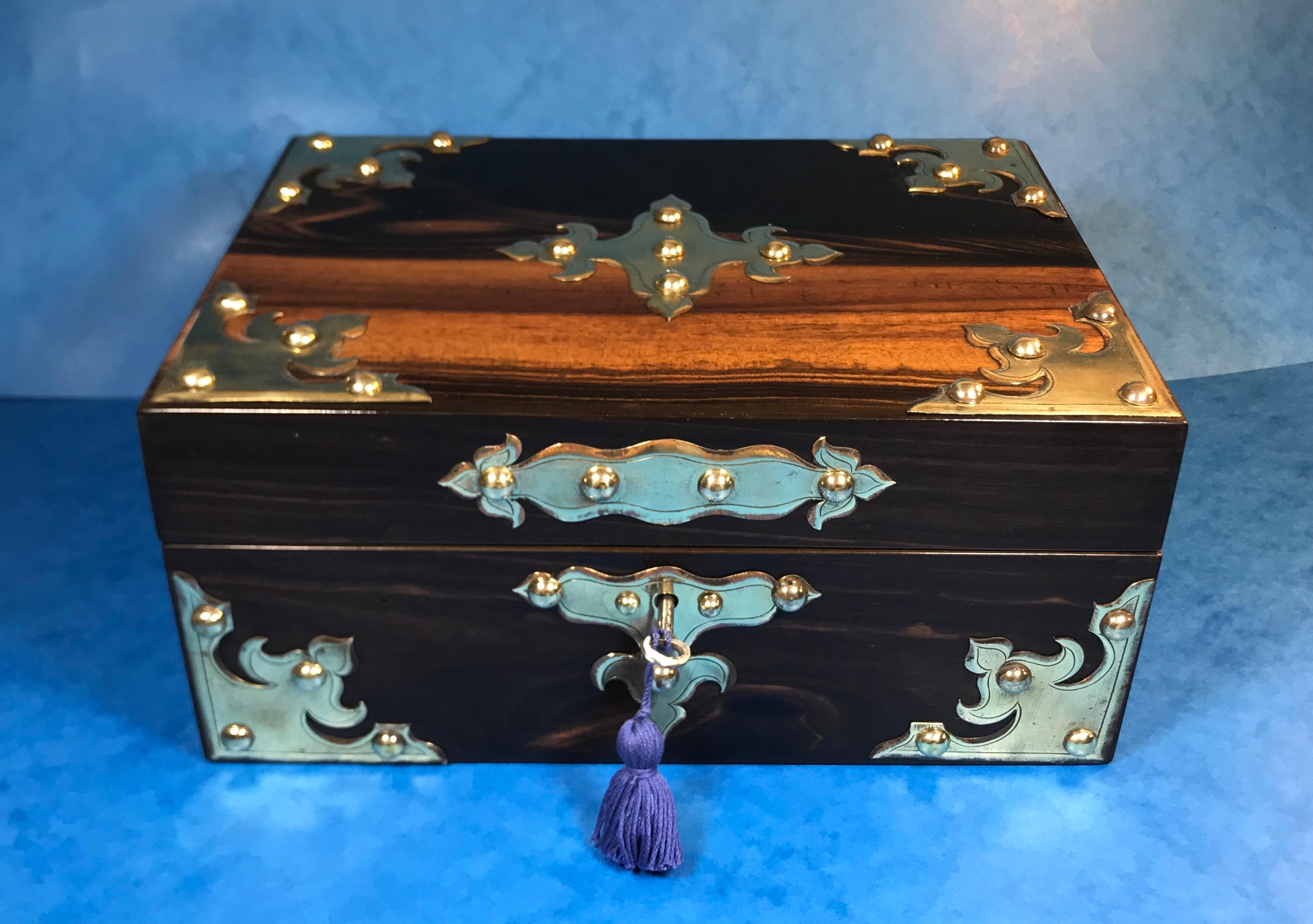 Victorian Coromandel jewellery box.
A striking brassbound Coromandel jewellery box with Coromandel top and front and fruitwood sides and back, dating back to circa 1860, featuring a working lock and key. The box houses its original tray, the