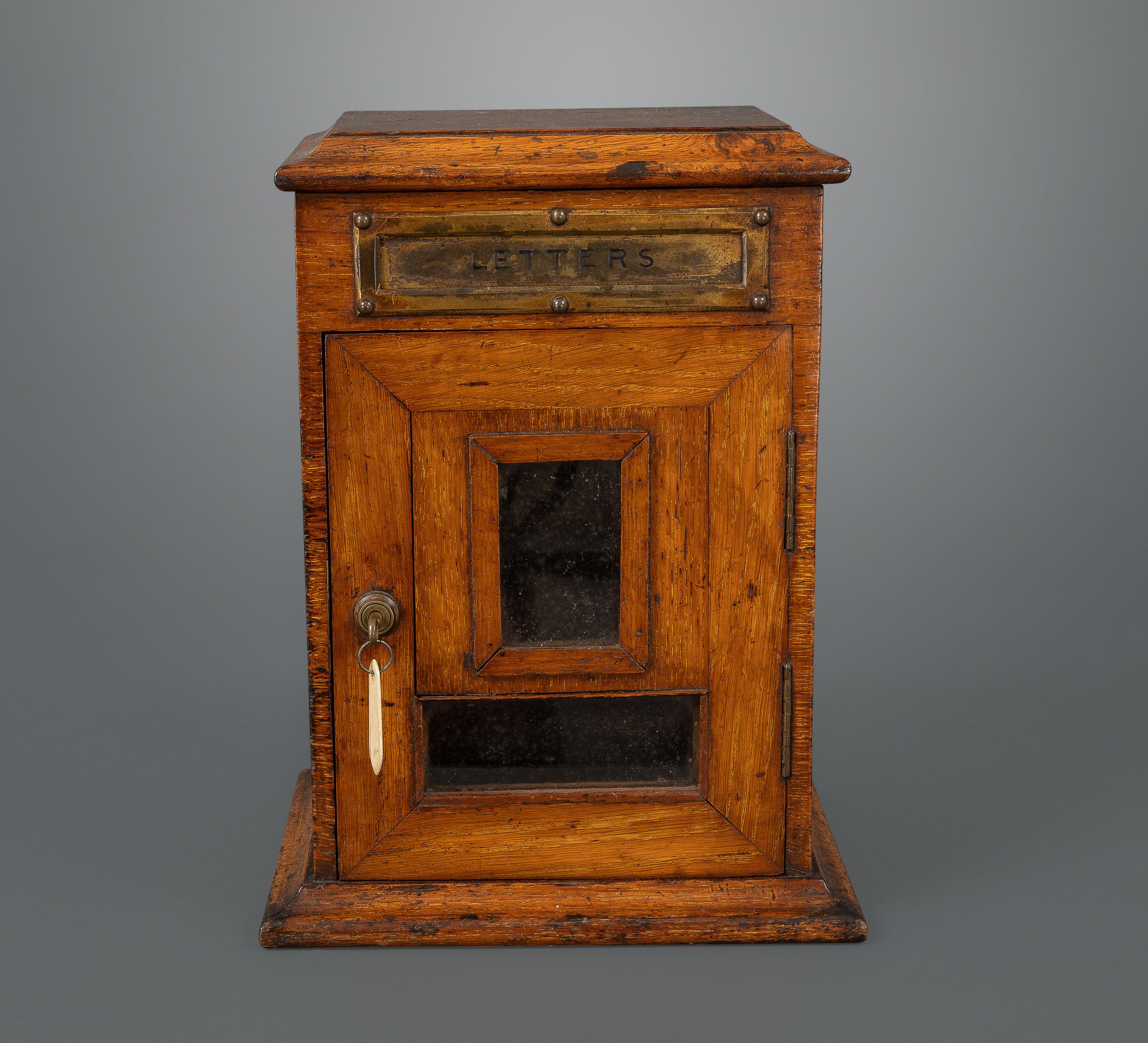 With a brass slot stamped “LETTERS” above a hinged door with two glazed panels and a self-locking Brahma brass lock (original key included). Mail boxes of this type were fixtures in the entrance halls of every Victorian and Edwardian country house