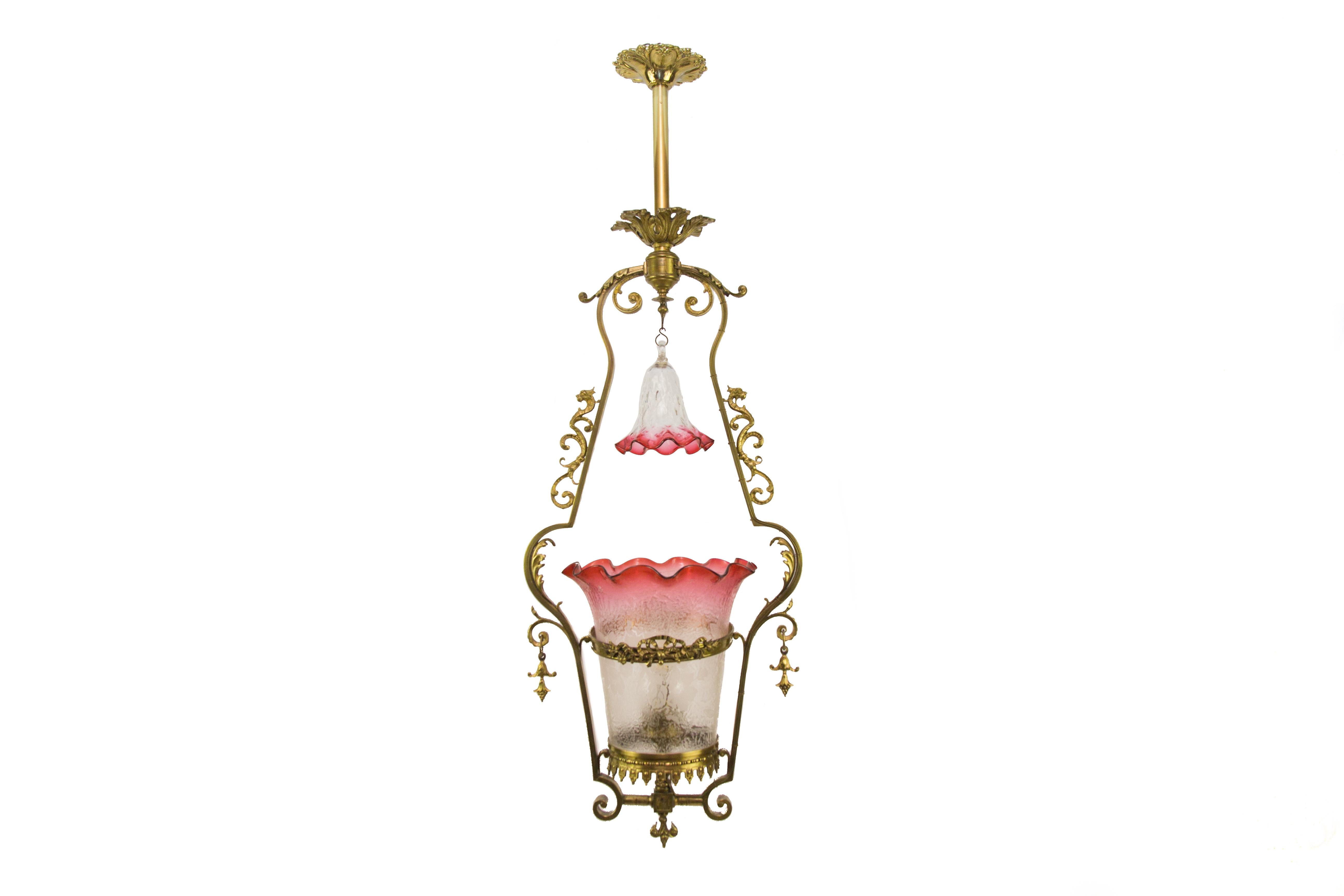 Victorian cranberry glass and bronze pendant hall light.
Victorian electrified gas pendant hall light with etched cranberry glass shade and a gorgeous cranberry glass bell that hangs from the top. The light fixture is from the late 19th Century and