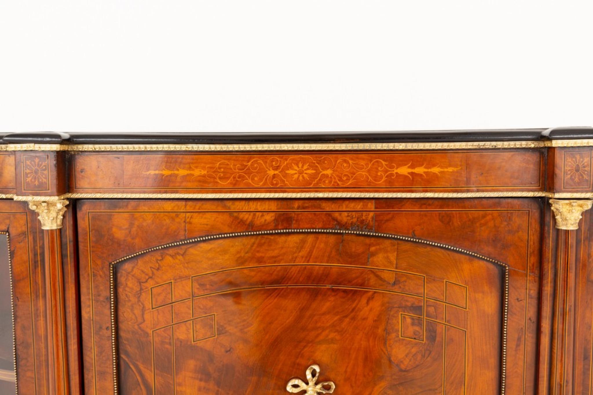 This Victorian credenza is raised upon ebonised turned feet
Circa 1860
Hand crafted from burr walnut with a lovely patina
The credenza having a central door featuring a Sevre style porcelain plaque flanked by turned columns
The end cupboards being