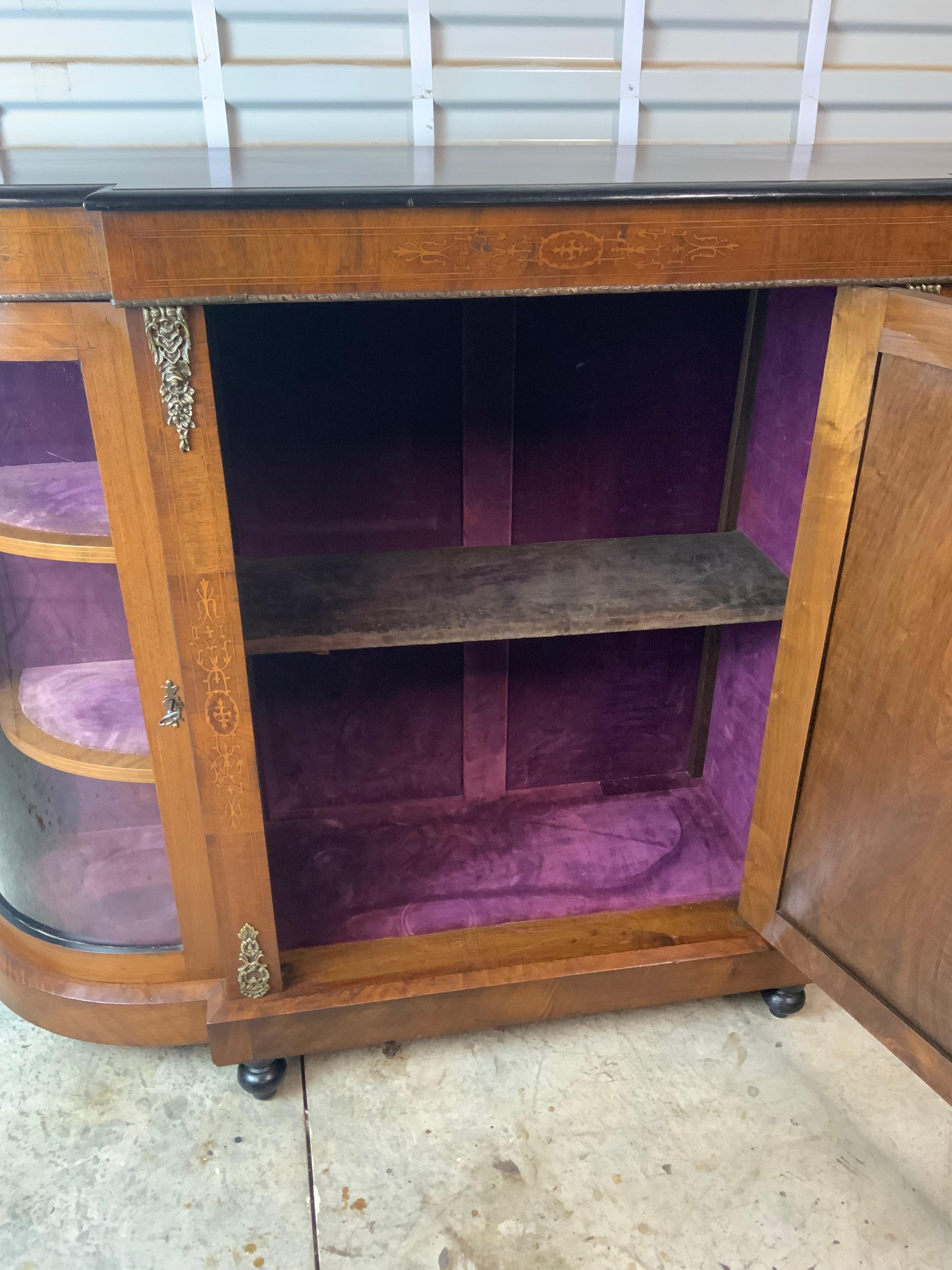 A very nice Victorian Walnut inlay Credenza with the original velvet fabric on the interior walls and shelves.  All the locks are working with the original key.   Very good original surface that has a mellow golden color to the Walnut and a great