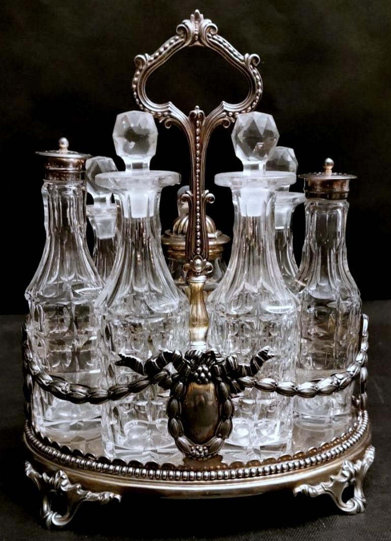 We kindly suggest you read the whole description, because with it we try to give you detailed technical and historical information to guarantee the authenticity of our objects.
Exceptional silver plated cruet with crystal bottles; has a beaded edge