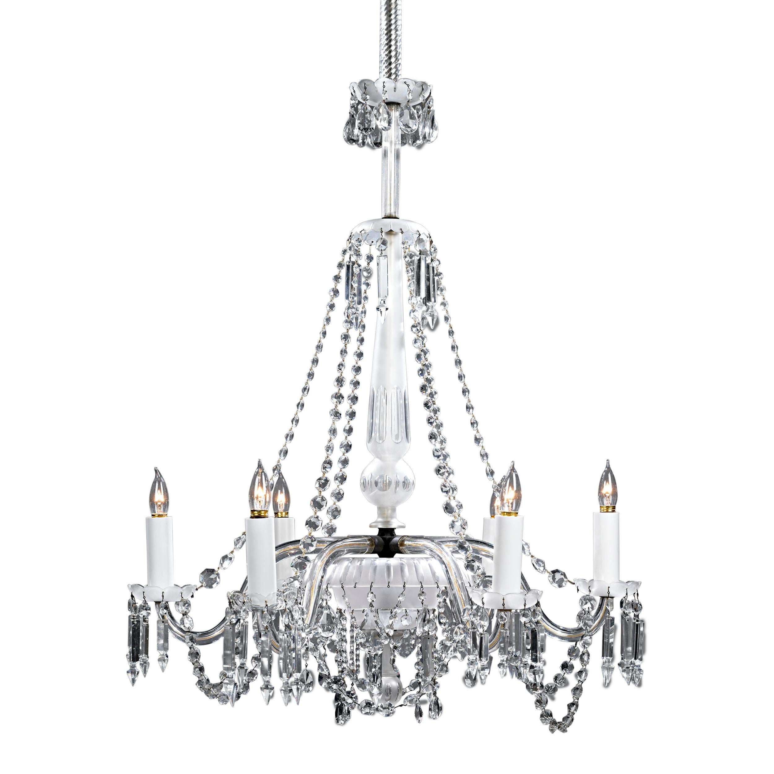 Hand-cut crystal bells, bead swags and prisms adorn this remarkable English crystal chandelier. The six-light chandelier is of exceptional quality, and its crystal adornments beautifully cast the light from its electric 