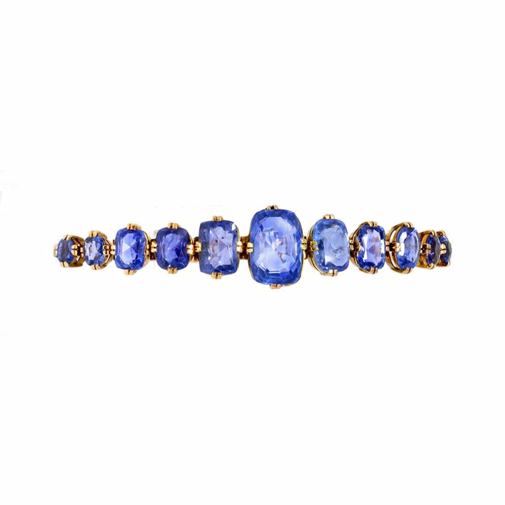 Fantastic Victorian 18-karat gold and sapphire bracelet, set with a graduated line of cushion-shaped sapphires weighing approximately 22.50 carats, completed by a simple link strap, gross weight 11.0 grams, length 7.5 inches, width 0.75 inches. 
The