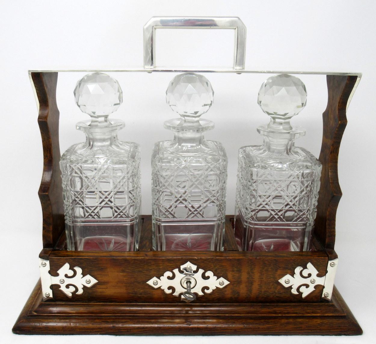 A very impressive early Victorian three handcut crystal decanter oak framed Tantalus of outstanding quality, of English origin, complete with its original working lock and original key.

This exceptional example is mounted with a heavy gauge