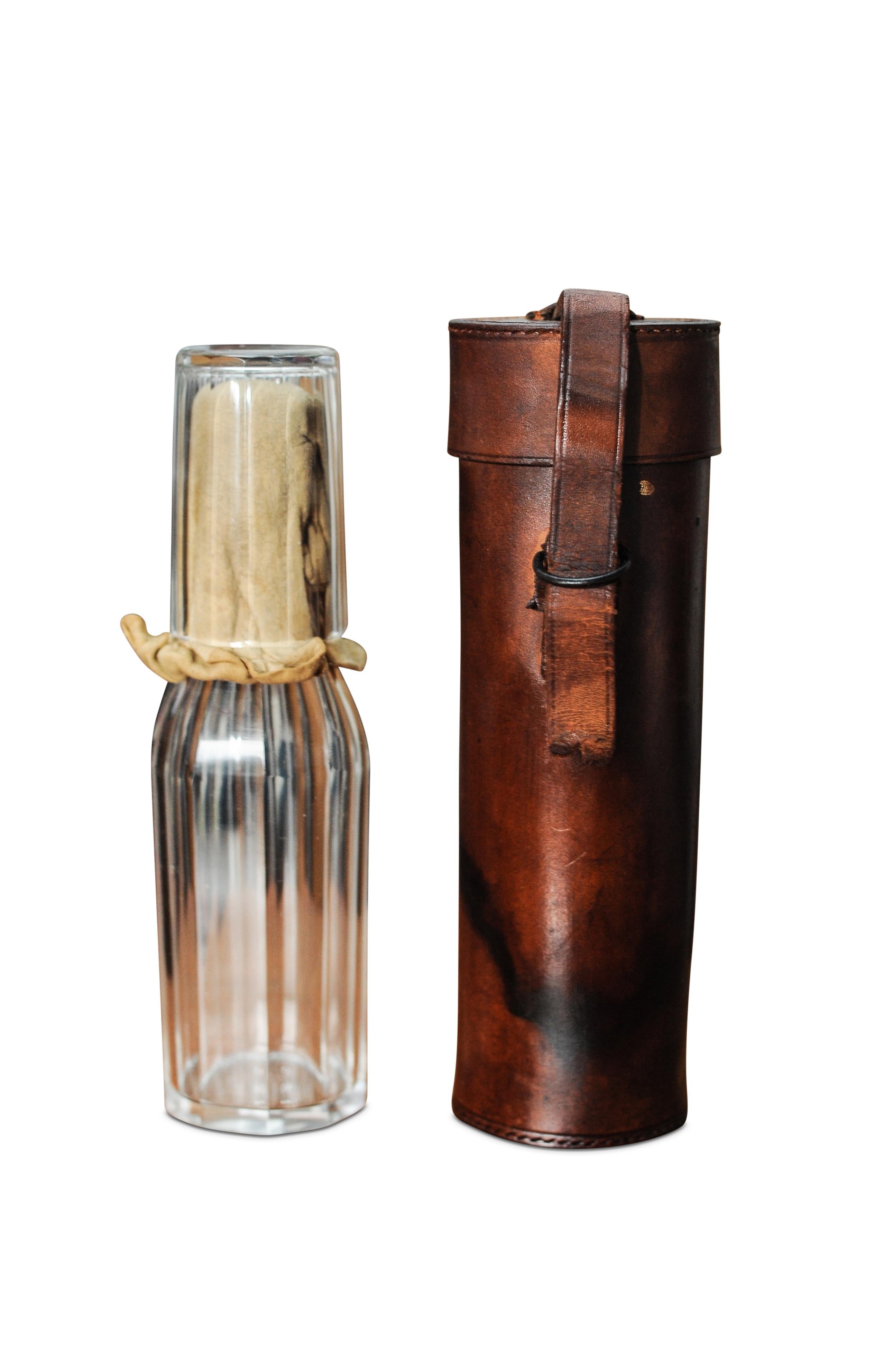 A Victorian 1800's cut glass white metal mounted hunting flask, of faceted cylindrical form with screw lid, together with a matching cup, 7cm high, contained in a handmade cylindrical leather case.