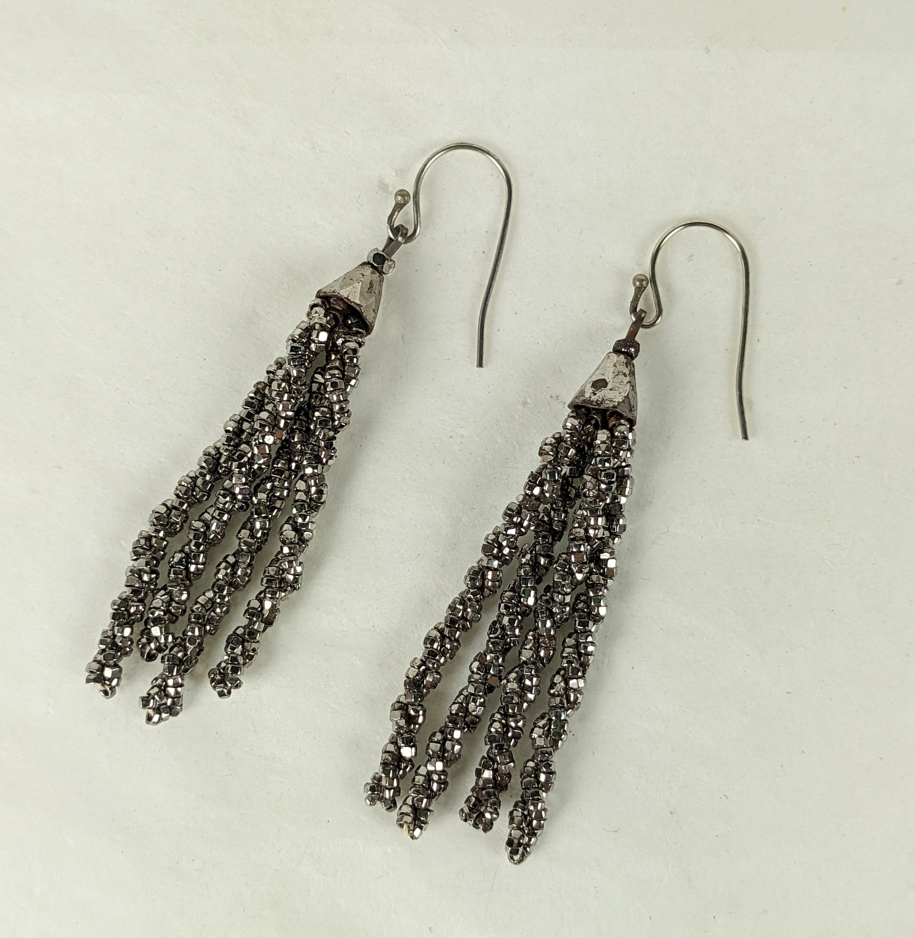 Victorian Cut Steel Tassel Earrings from the 19th Century. Tiny cut steel beads are strung into twists under a cut steel faceted cap. Ear wires later, 19th Century France.
Tassel 2