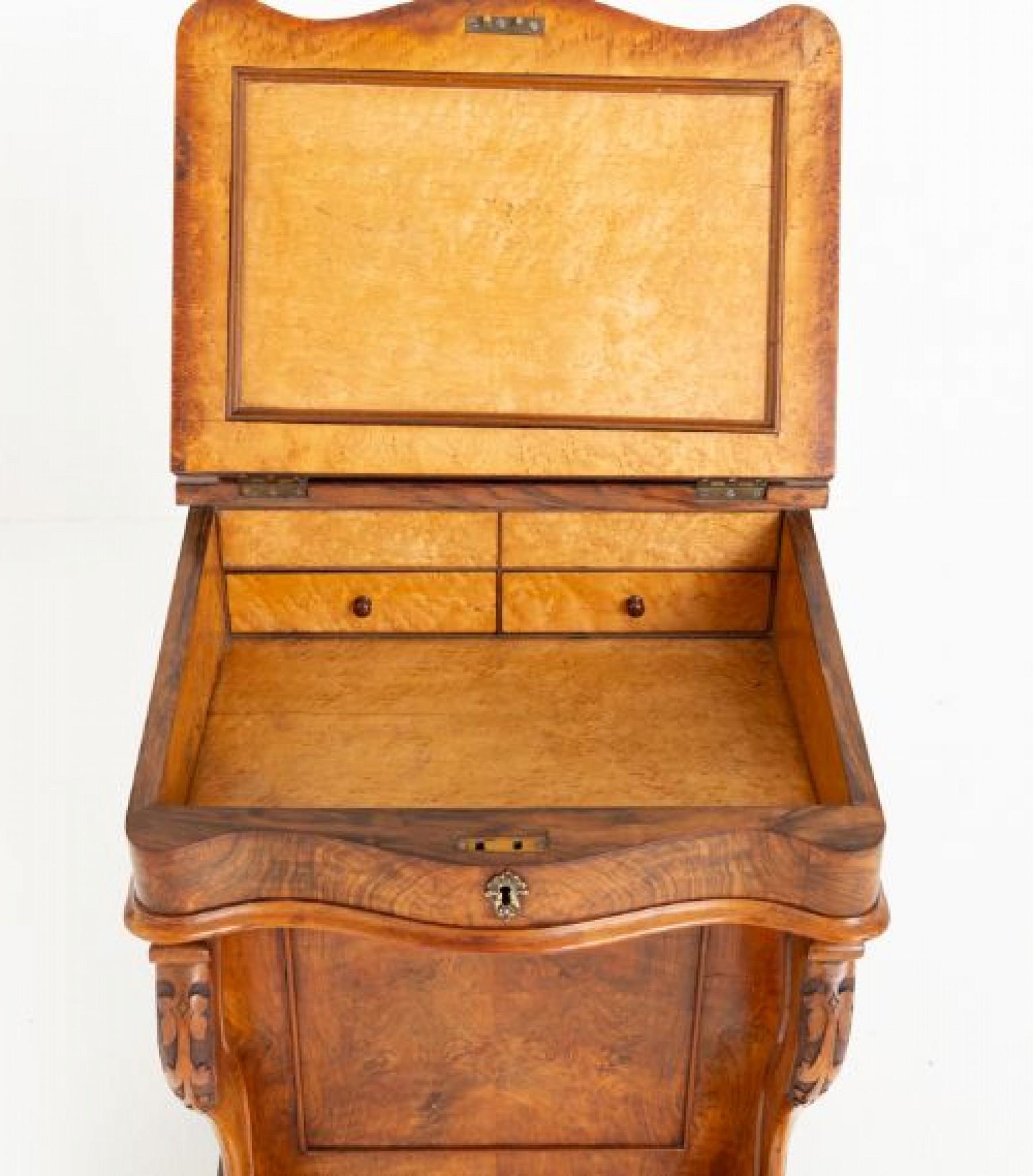 Victorian burr walnut Davenport.
This davenport features 4 mahogany lined drawers to the right hand side and faux drawers to the left hand side.
Circa 1860
The Davenport is raised upon turned feet with carved and shaped supports.
The leather top