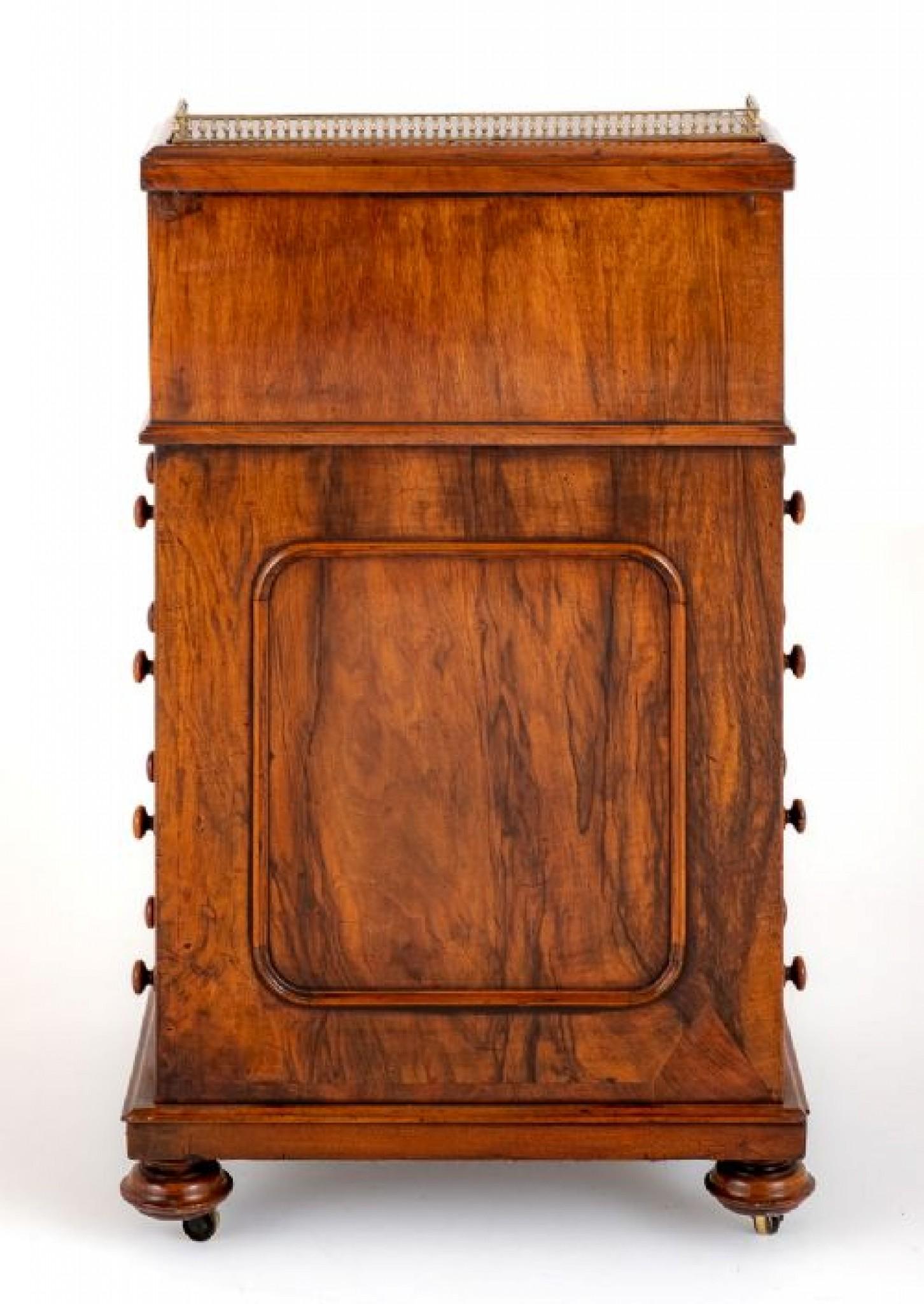 Here we have a typical Victorian walnut Davenport.
circa 1860
The Davenport having 4 mahogany lined drawers to the right hand side and 4 faux drawers to the left hand side.
The Davenport is supported on turned feet with shaped and carved