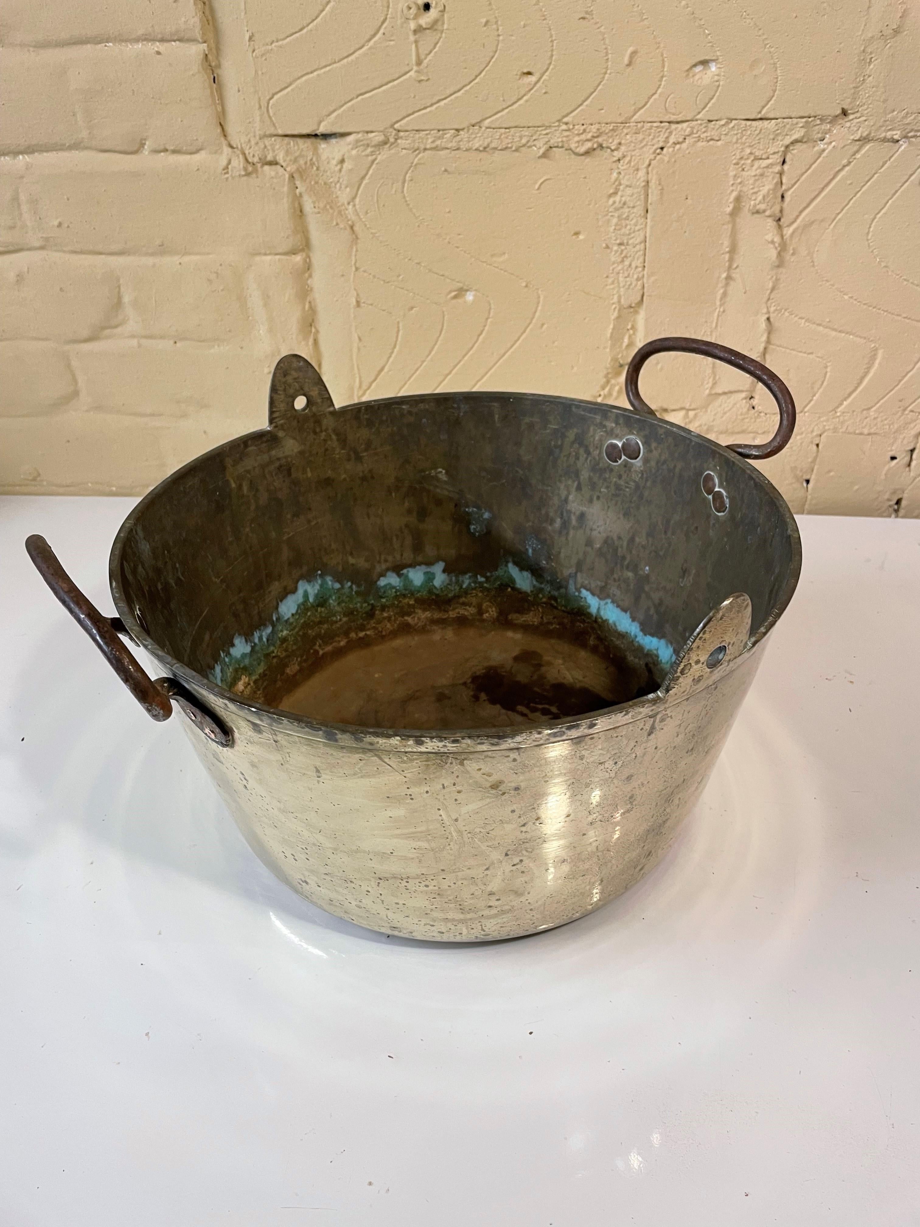 Good quality brass jam pan with iron carrying handles with copper rivets alongside holes that would have been used with a hook to suspend the pan over a fire. Probably dates from the 1870s and is in good vintage condition. Would make a highly