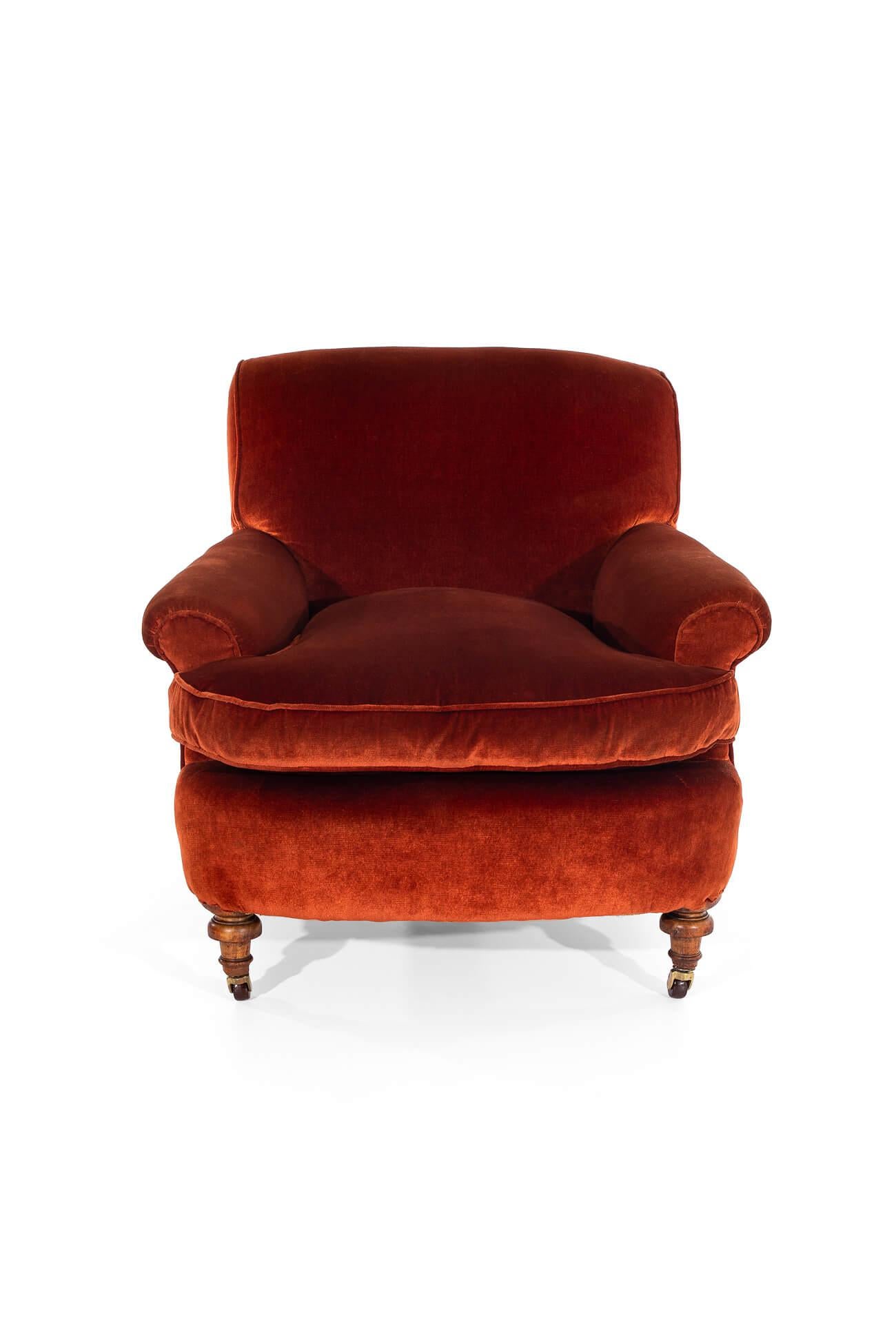 A fabulous burnt orange armchair of generous proportions.

Featuring a high back, scrolling arms and inviting wide and deep seat.

Mahogany frame with turned front legs raised on original brass castors.

Fully reupholstered with hessian and calico
