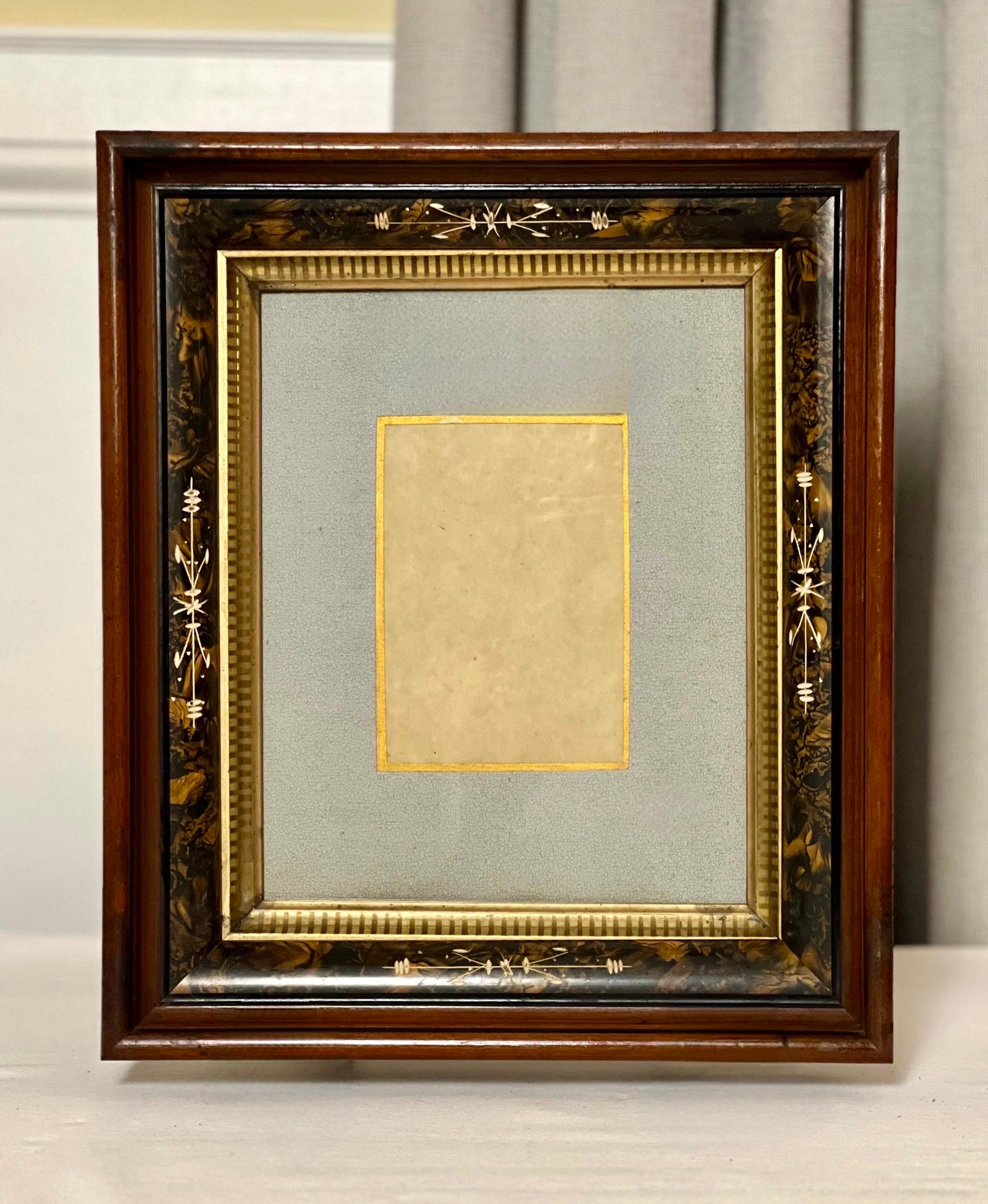 Victorian deep well walnut and etched plaster frame matted under glass, late 19th-early 20th century.

Elegant handcrafted wood frame layered with an ebonized band, a decorated, etched plaster inner frame with carved gilt wood trim and original soft