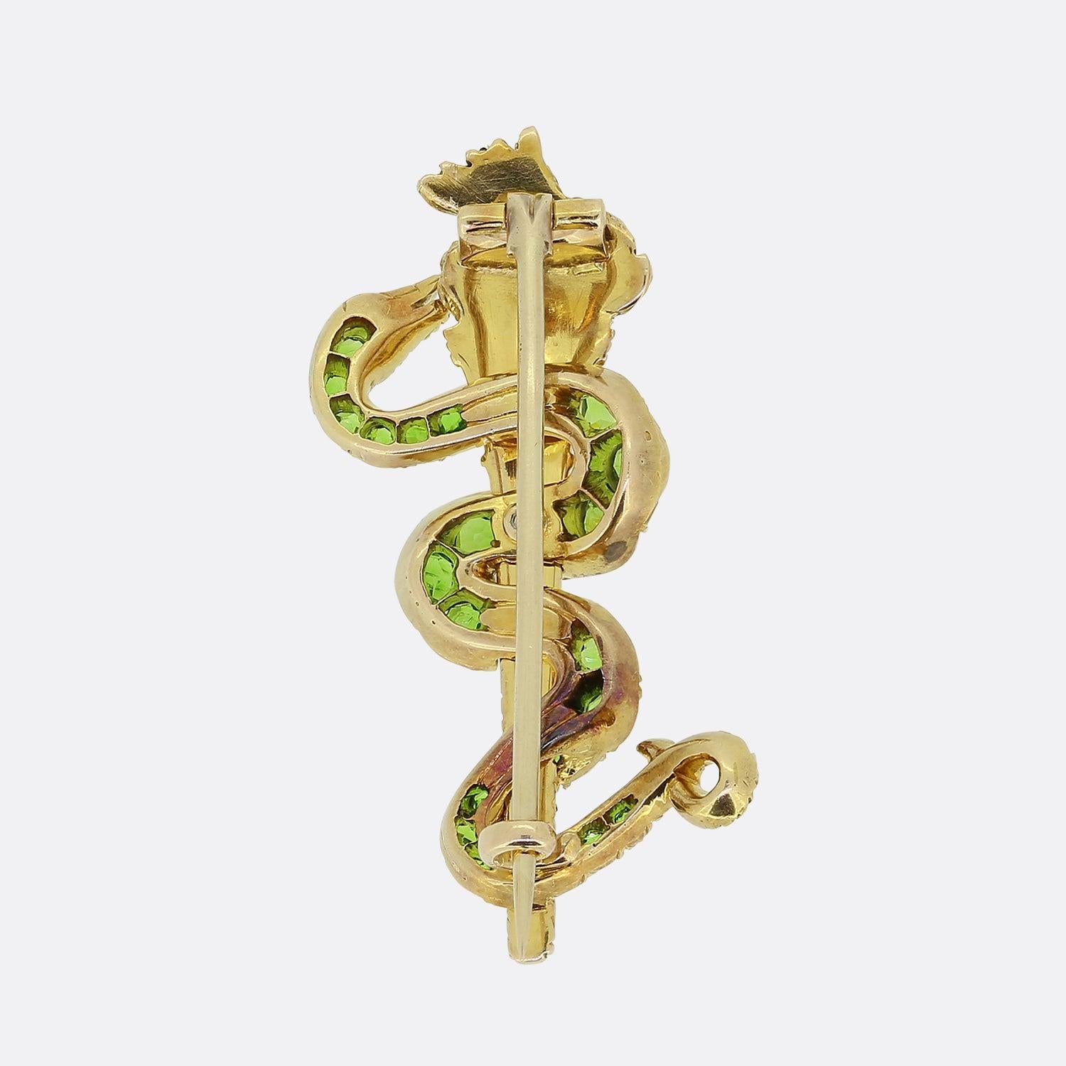 Here we have a truly remarkable brooch dating back to the Victorian era. At the centre of this 15ct yellow gold piece, a flaming torch has been crafted with a snake wrapping itself around the main shaft. Both motifs showcases expert craftsmanship