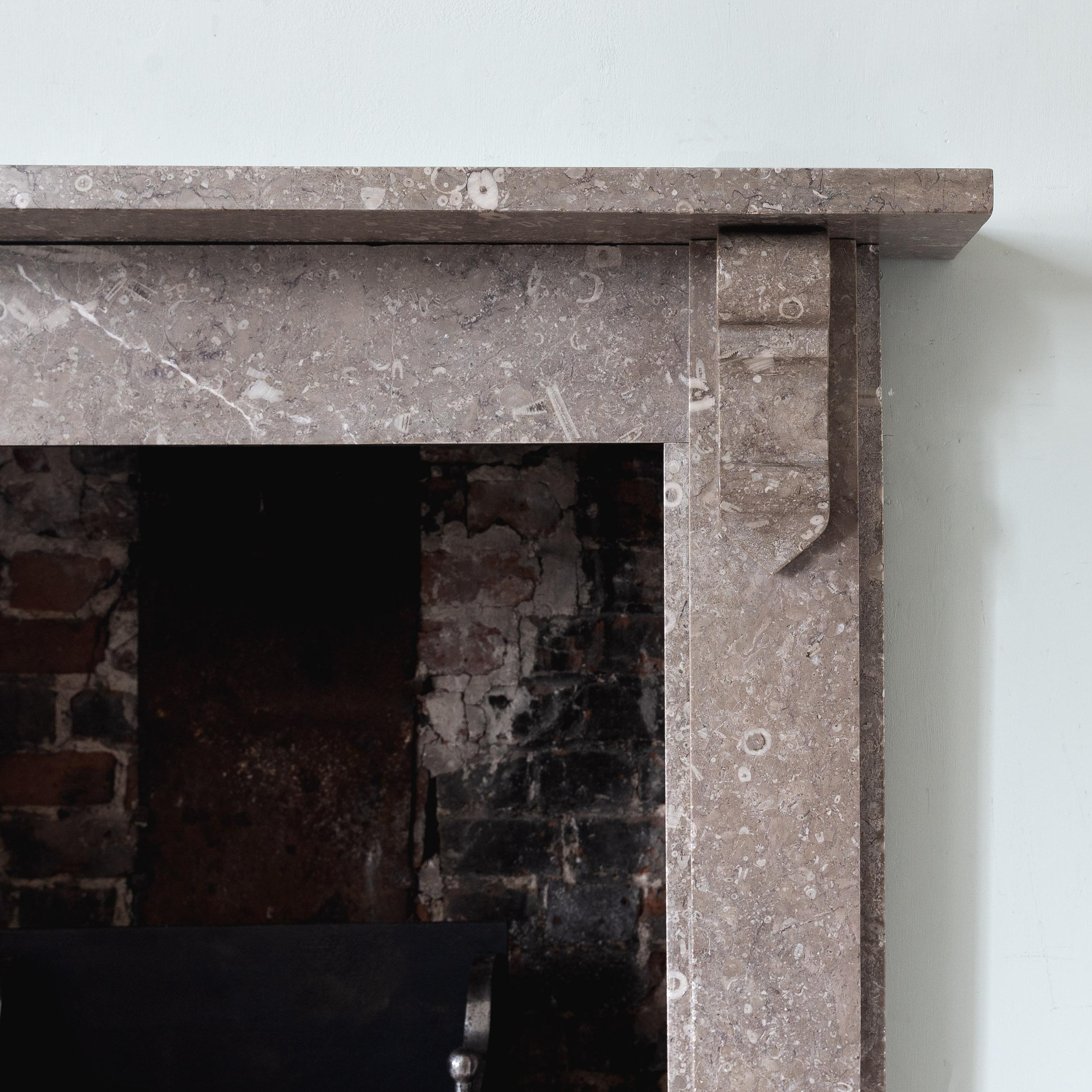 A small Victorian Derbyshire fossil limestone fireplace, the plain shelf supported by Gothic corbels. A simple and elegant design in fantastic and unusual material.

Opening width 86 cm x 96 cm high, Outside jamb to jamb 120 cm wide.

Ready for use