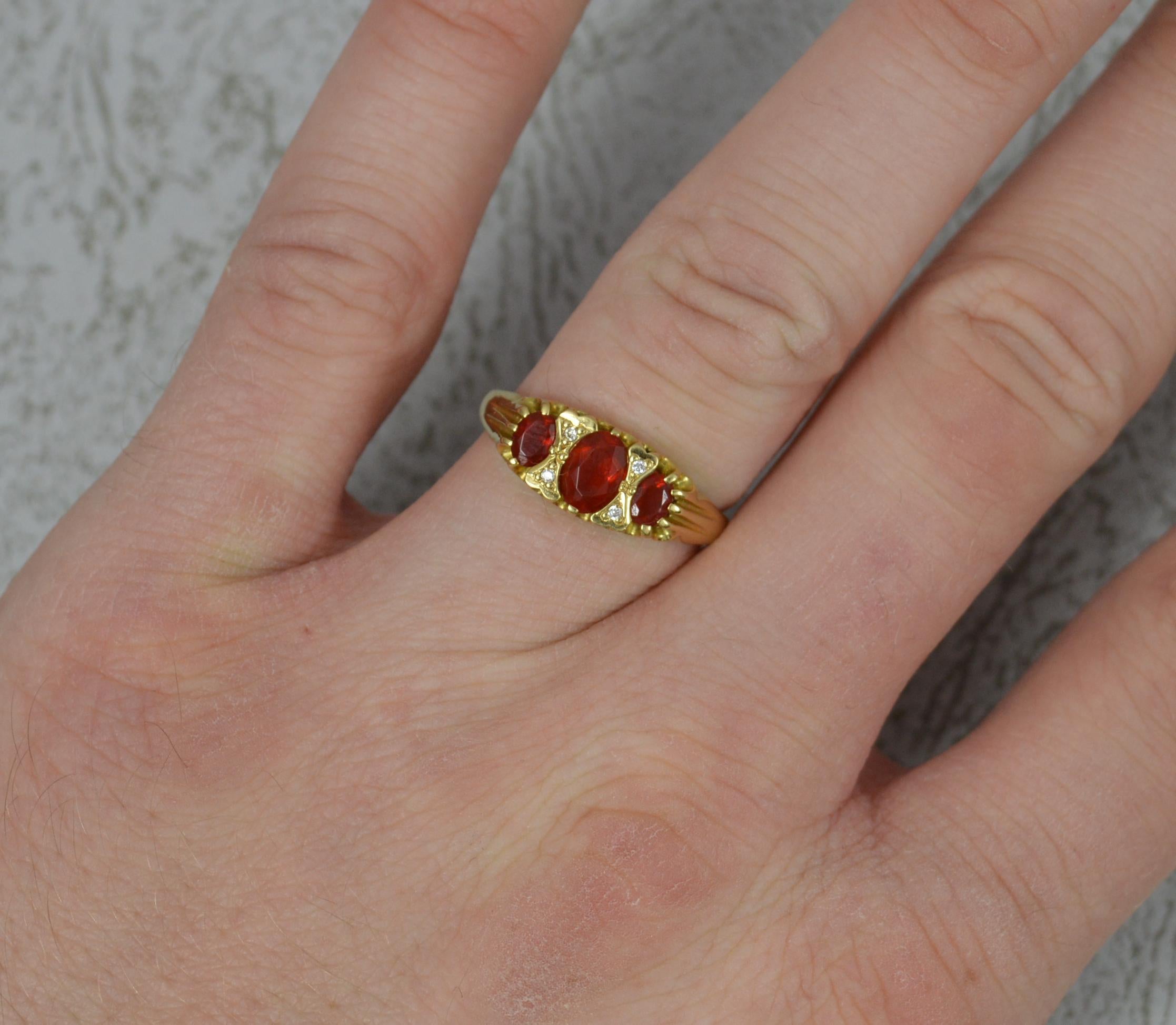 A beautiful ladies 18 carat gold fire opal and diamond cluster ring.
Solid 18 carat yellow gold example.
A Victorian design featuring three oval cut fire opals with pairs of small diamonds in between. Very deep coloured stones.
12mm x 7mm cluster