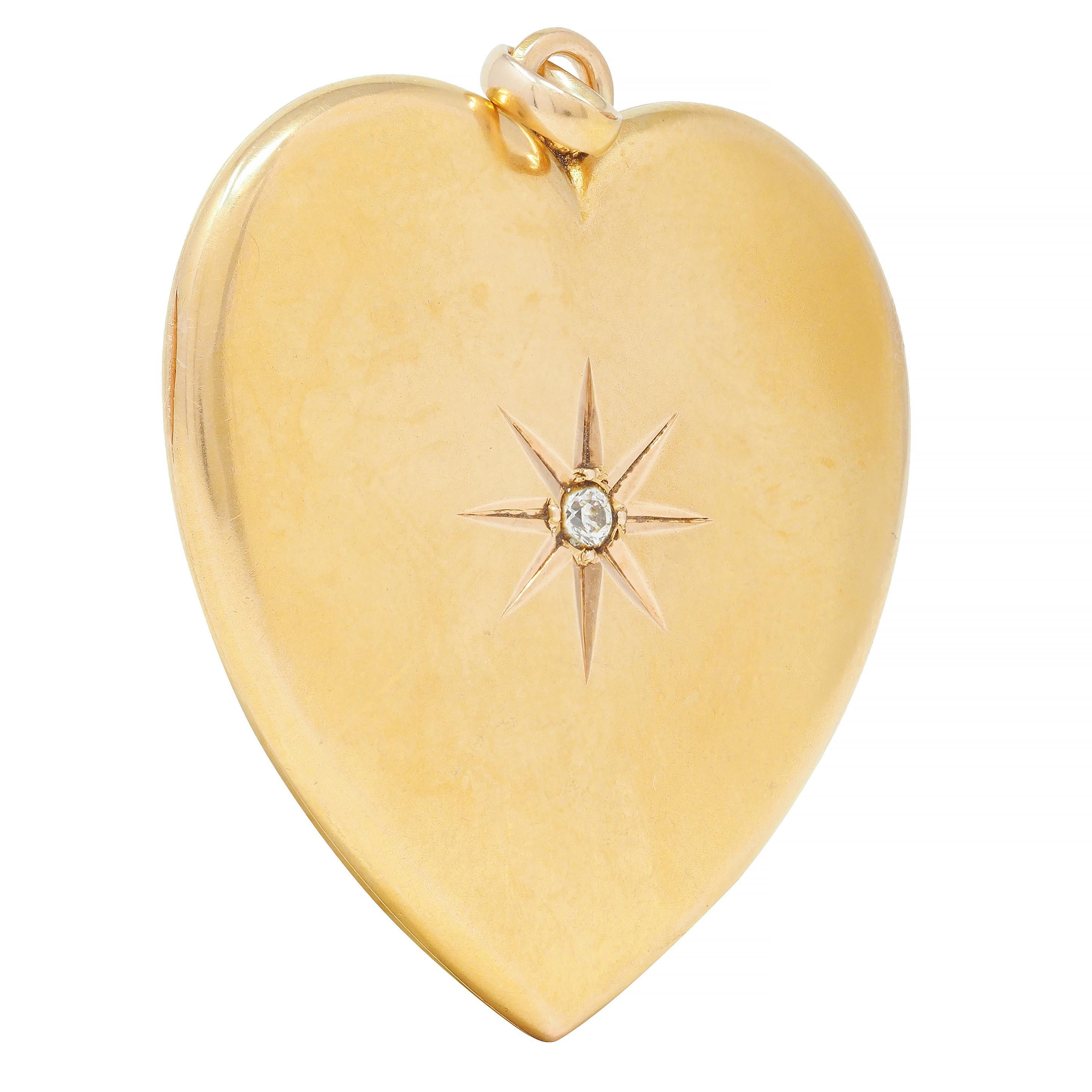 Designed as a heart shape centering an old European cut diamond 
Weighing approximately 0.08 carat - eye clean and bright
Bead set in the center of an engraved starburst motif 
Hinged and opens to reveal two heart-shaped recesses
Featuring removable