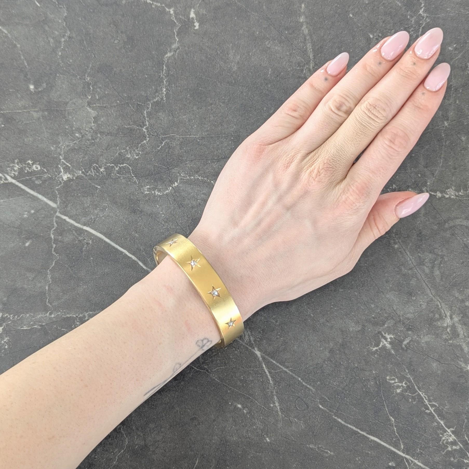Designed as an oval shaped bangle bead set with old mine cut diamonds
Weighing approximately 0.40 carats total - H color with VS2 clarity
Each set in graved star motifs across front
Opens on a hinge via press release closure
With chain
