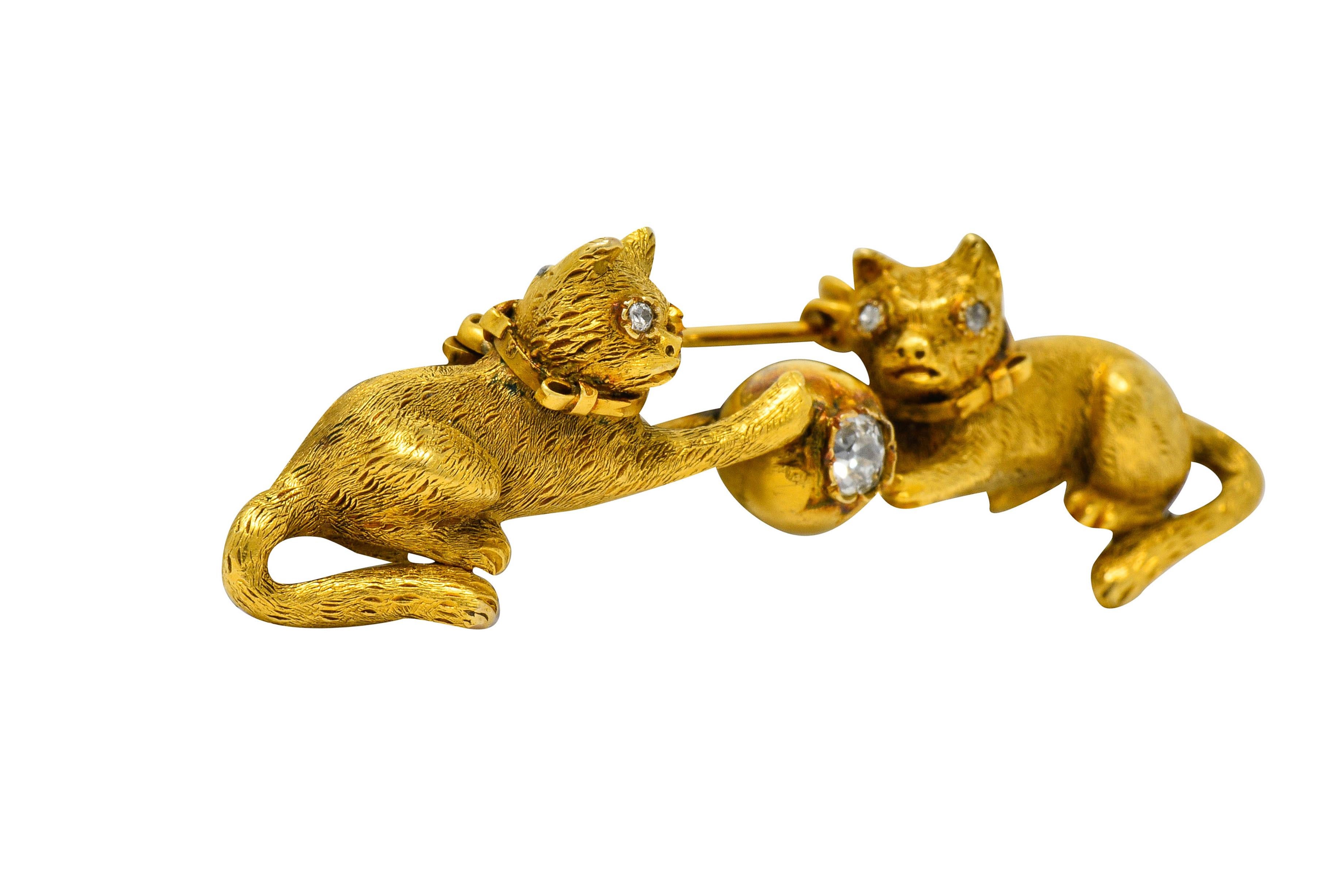 Bar style brooch designed as two playful kittens pawing a ball

Centering an old mine cut diamond weighing approximately 0.30 carat, J/K color with SI clarity

Kittens are highly rendered with textured fur

Eyes are bezel set old European cut