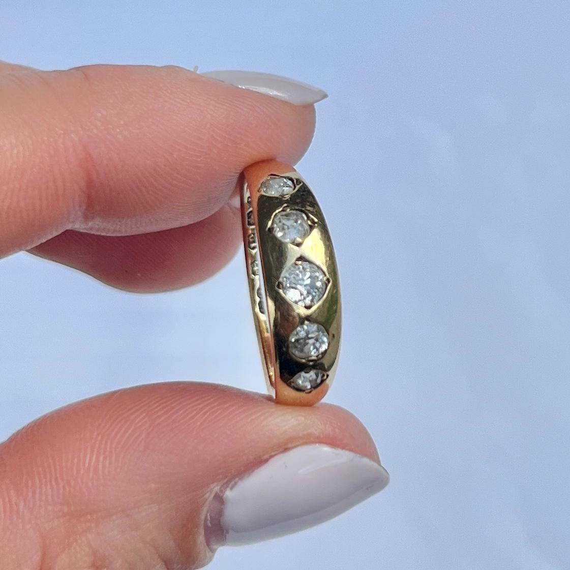 Set within this smooth 18carat gold band are five sparkling diamonds. The central diamond measures 20pts and the smaller diamonds measure 10pts and 7pts. The diamond total of this ring is 54pts. Fully hallmarked Birmingham 1885. 

Ring Size: O or 7