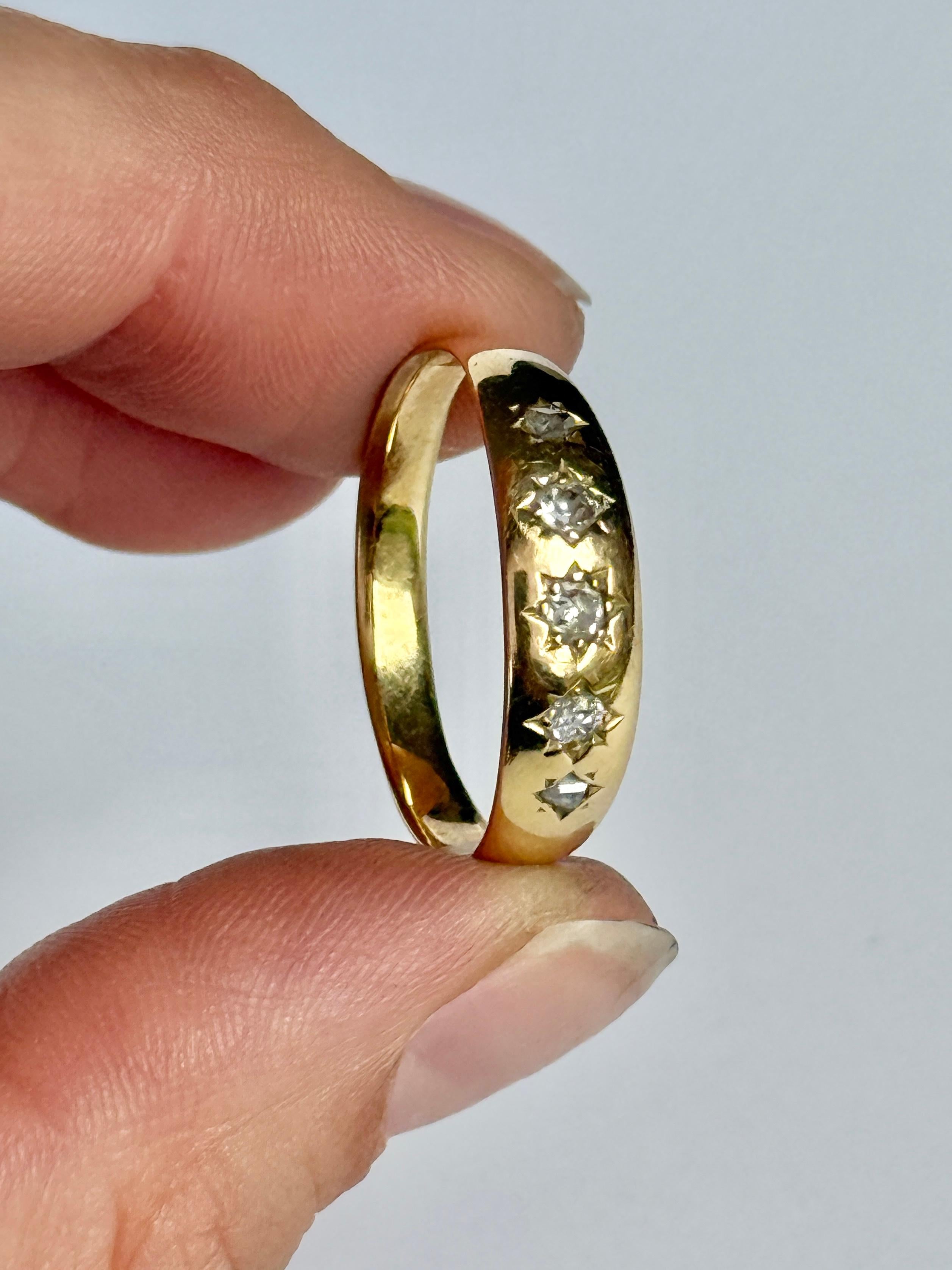 This gorgeous 18ct gold band holds five old mine cut diamonds totalling 25pts. They are bright and have a lovely sparkle and set in a star settings. 

Ring Size: U 1/2 or 10 1/4
Band Width: 6mm 
Height Off Finger: 1mm

Weight: 3.5g