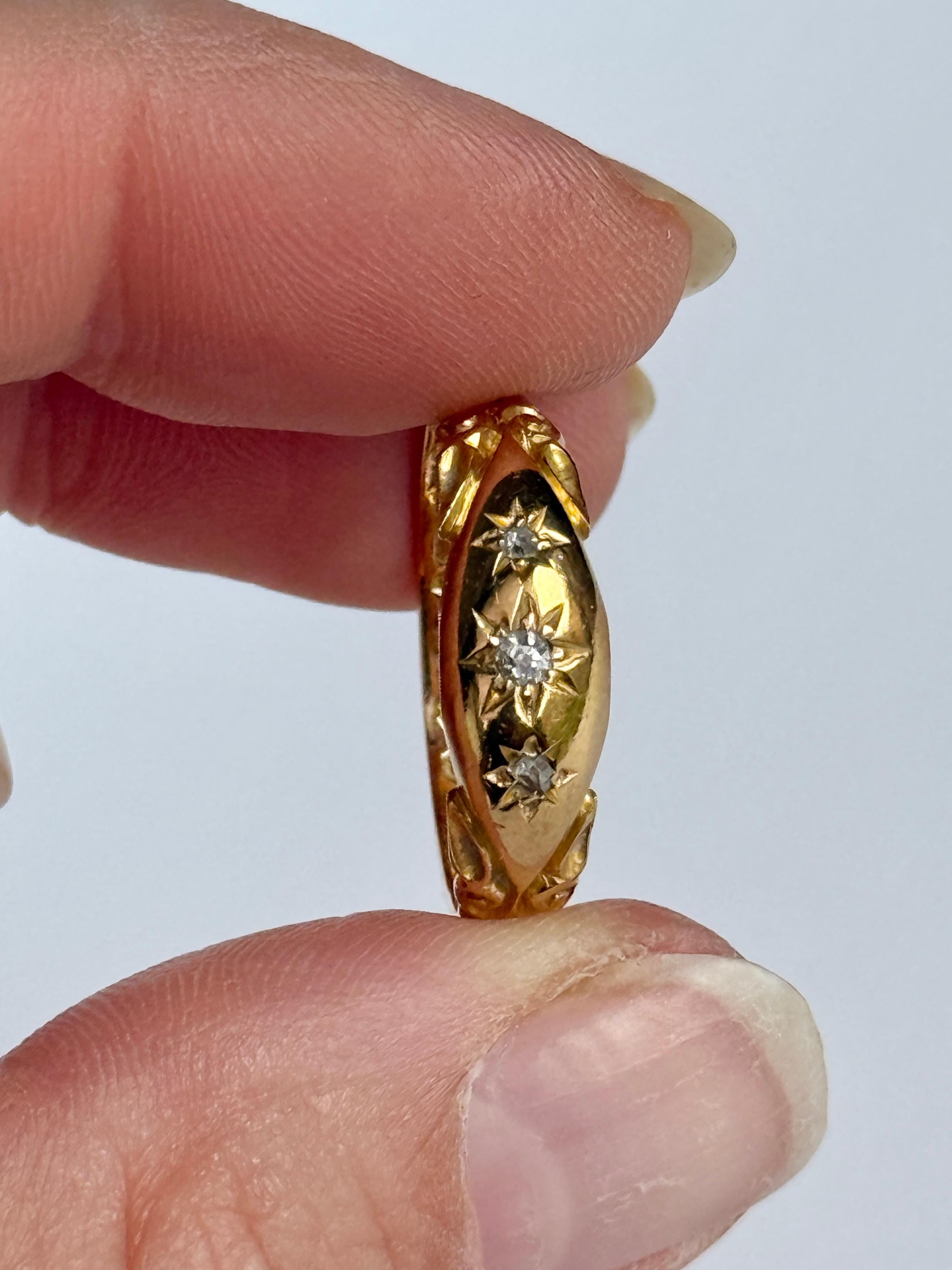 This gorgeous 18ct gold band holds three diamonds. The diamond total of this ring is  9pts. The central diamond measures 15pts. Hallmarked Chester 1902.

Ring Size: Q or 8 1/4 
Band Width: 6mm 
Height Off Finger: 1.5mm

Weight: 3.9g